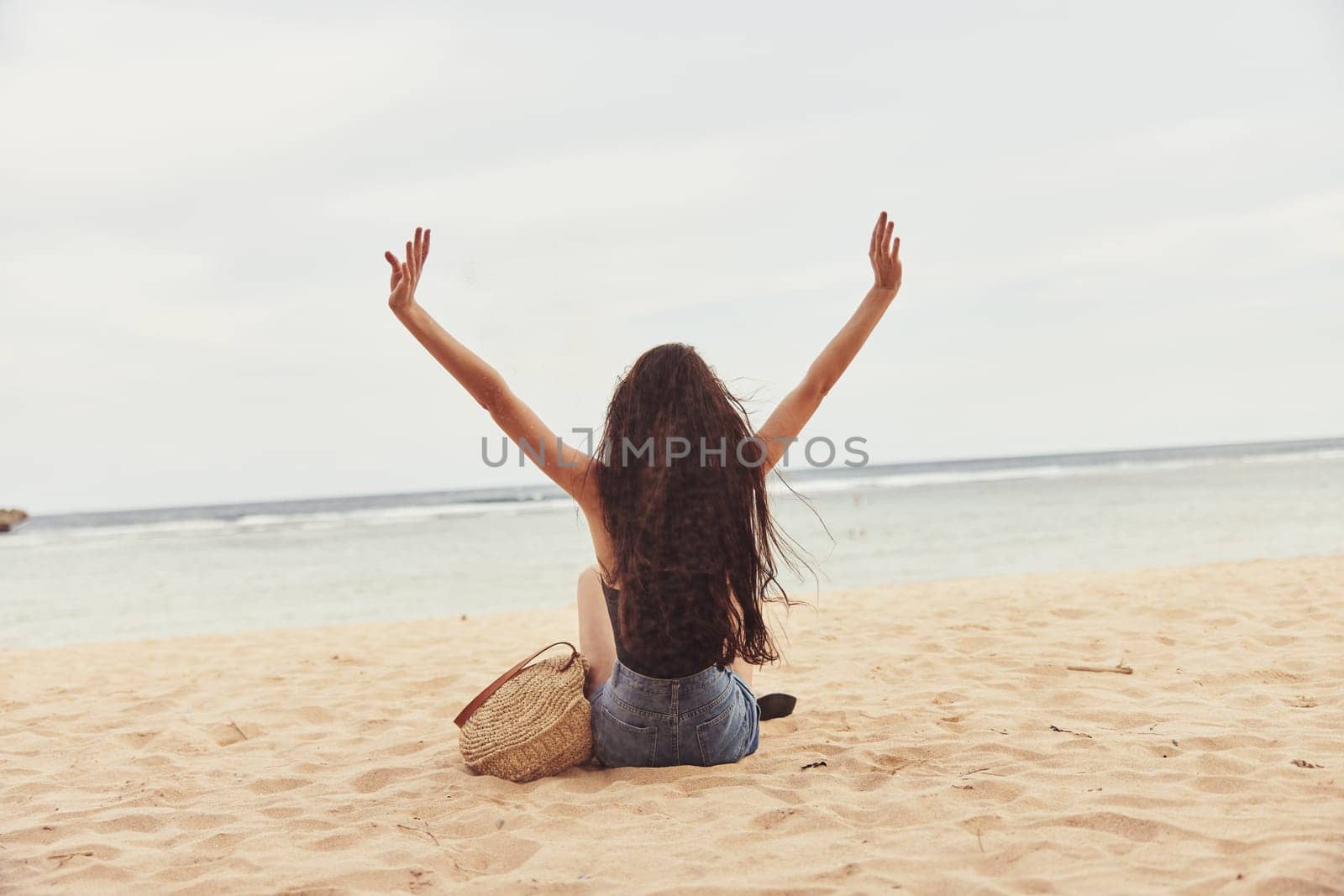 sun woman summer vacation freedom adult smile holiday sand model sitting coast young girl lifestyle nature beautiful beach carefree travel sea