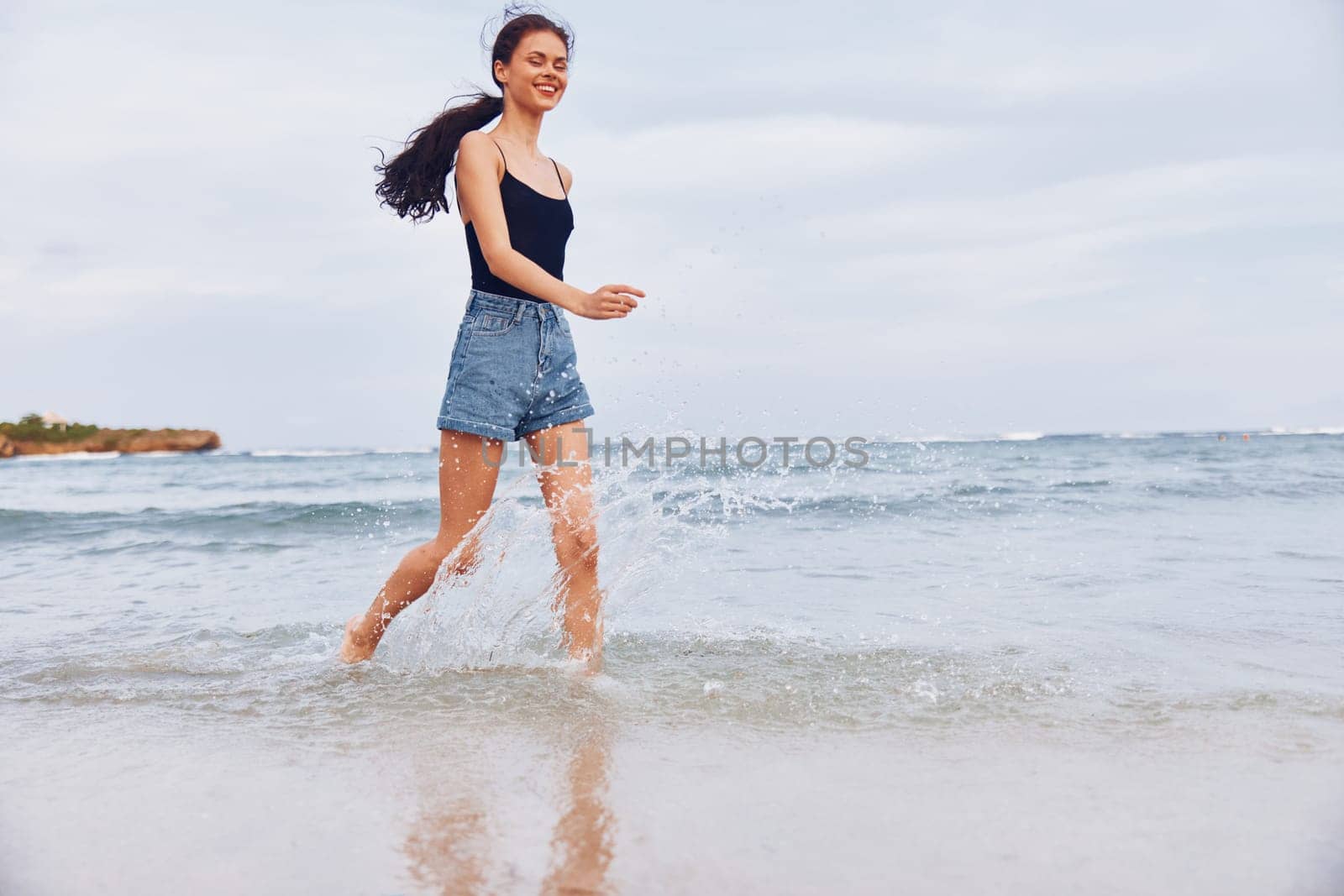 woman freedom tan active sun young sea beautiful hair sunset space smile positive ocean water summer travel lifestyle body beach running copy