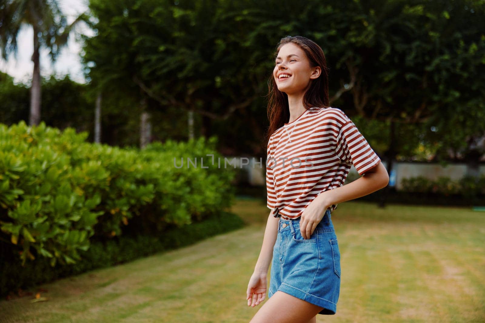 woman beautiful sunny smiling freedom walk nature t-shirt lifestyle park summer by SHOTPRIME