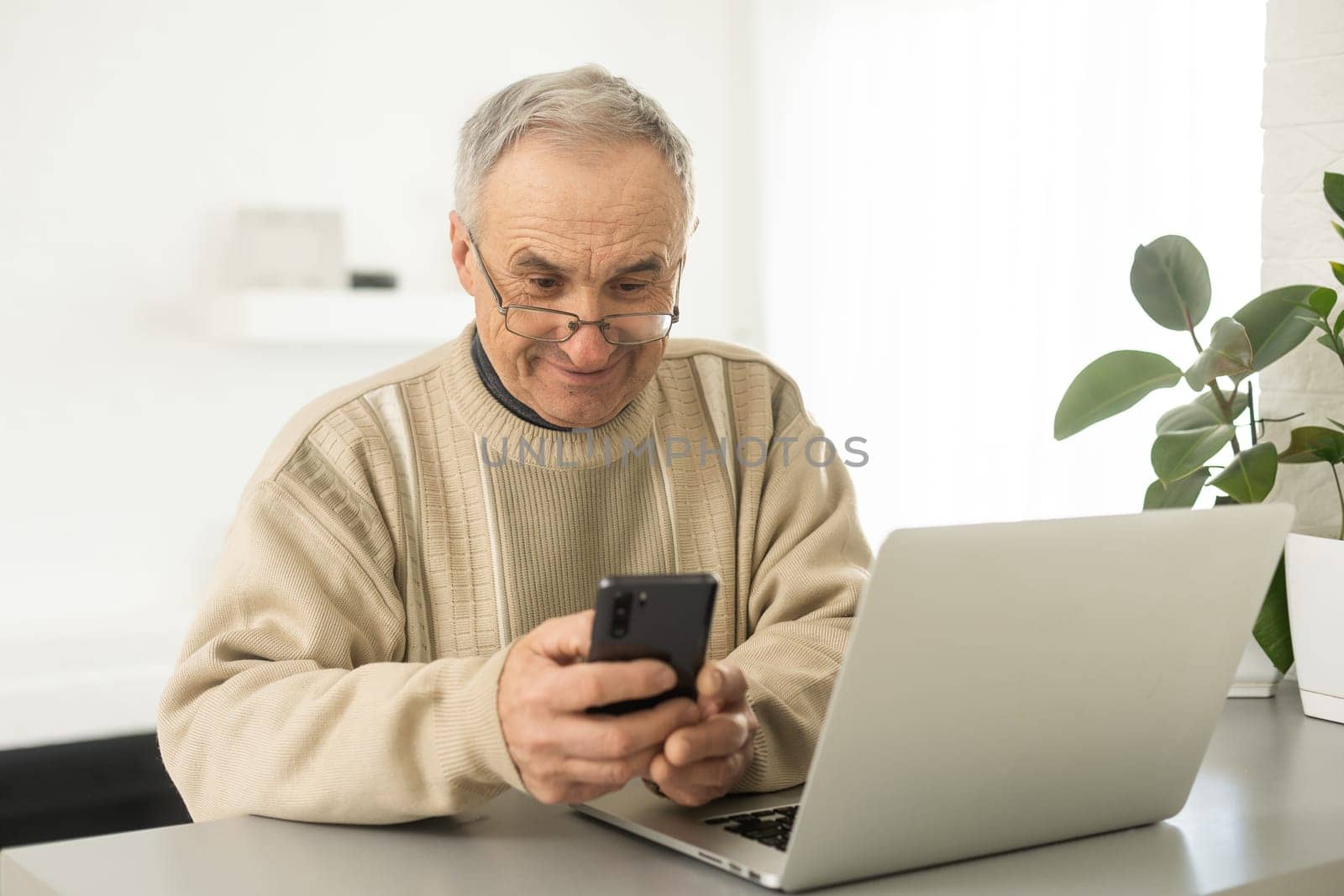 Pensive Senior Man Using Laptop Sitting At Home, Empty Space by Andelov13