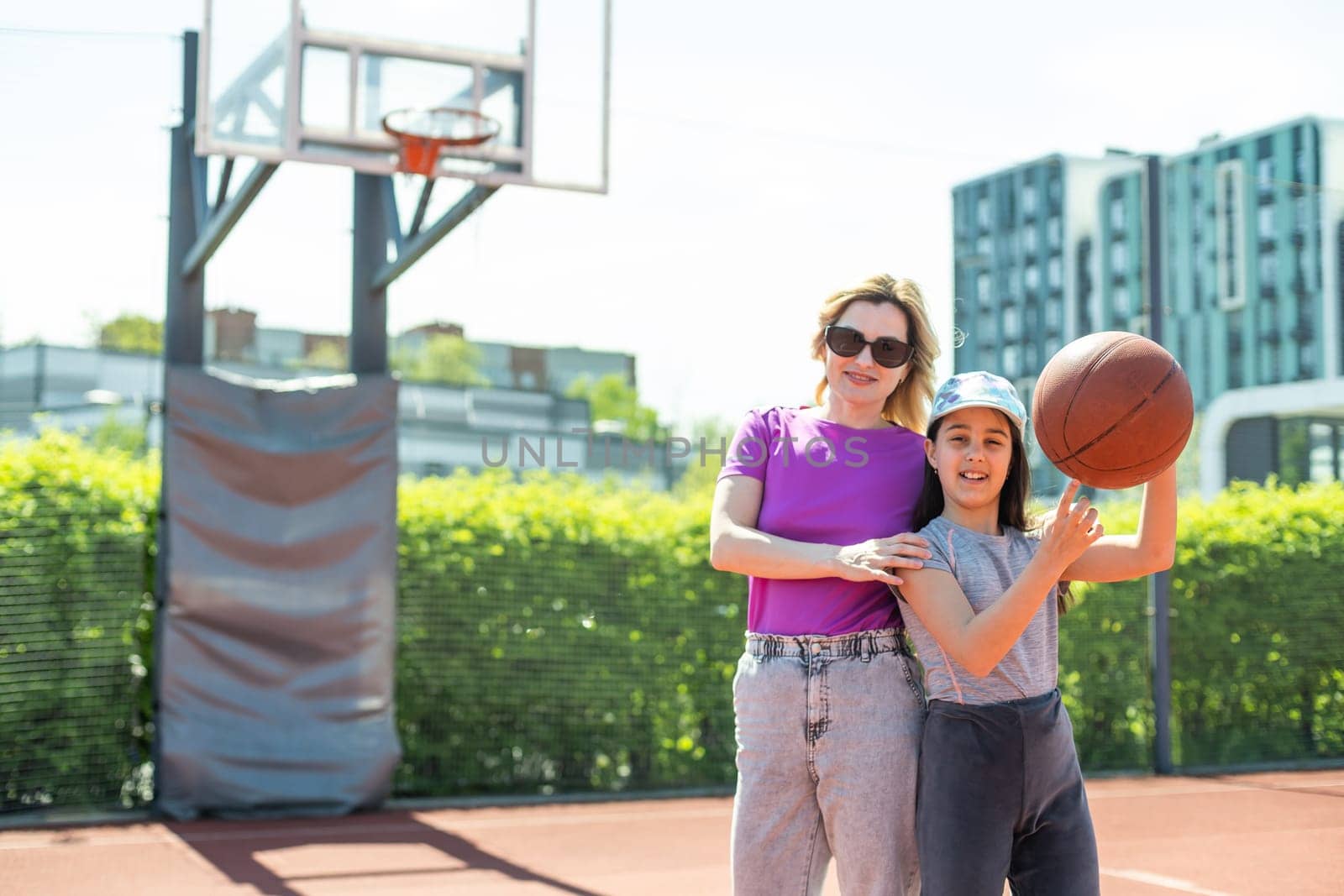 Mother and daughter playing basketball