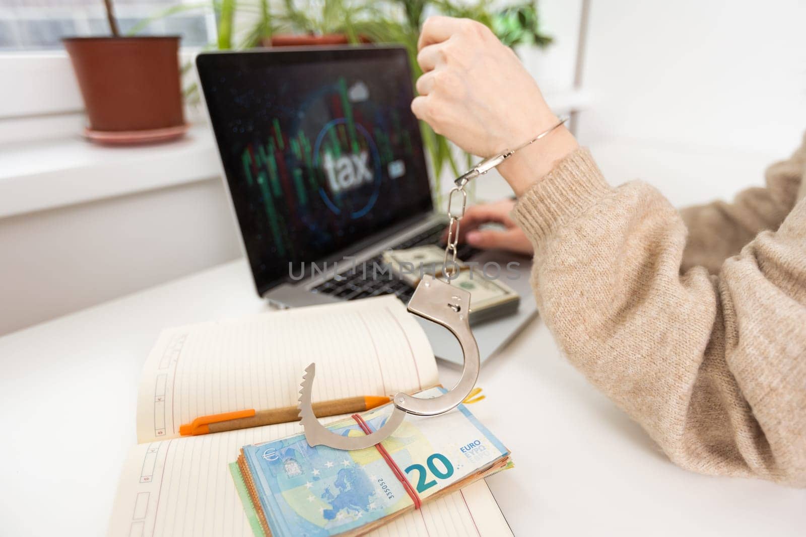 handcuff and money on laptop, Buying freedom, exchange freedom for money to escape from crime.