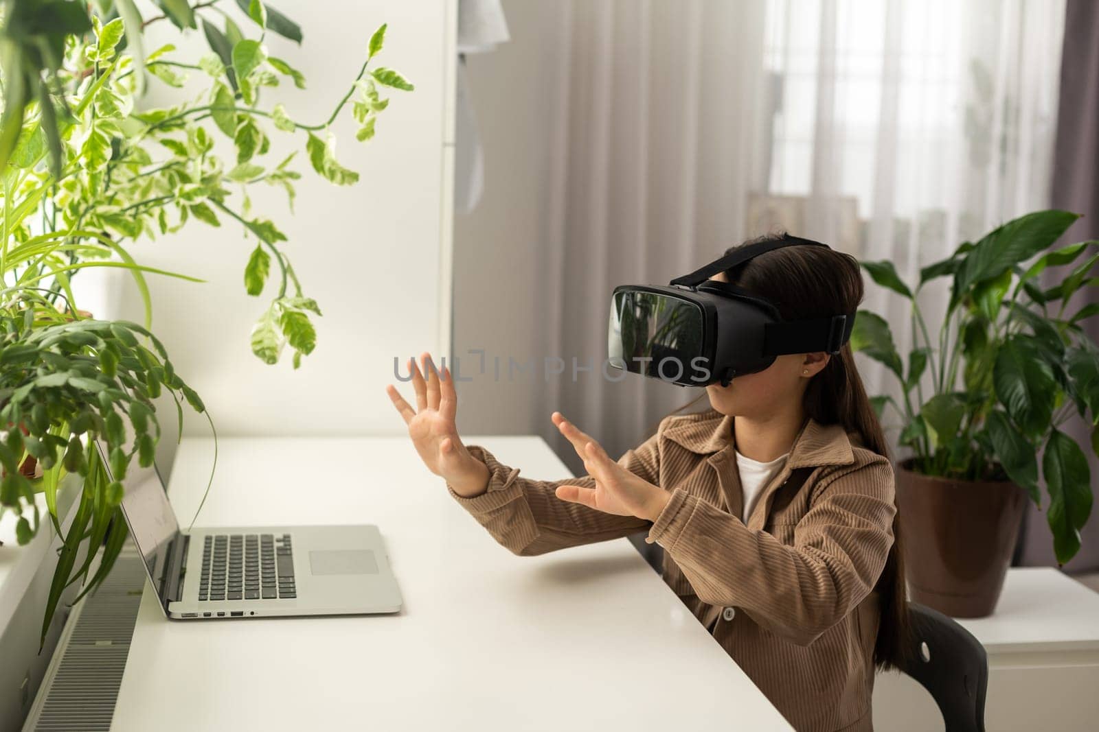 Virtual classes. Driving lessons. Science Class. VR technology. schoolgirl using virtual reality helmet. Virtual reality headset. Teenager student girl in classroom. Play game. Go around obstacles. by Andelov13