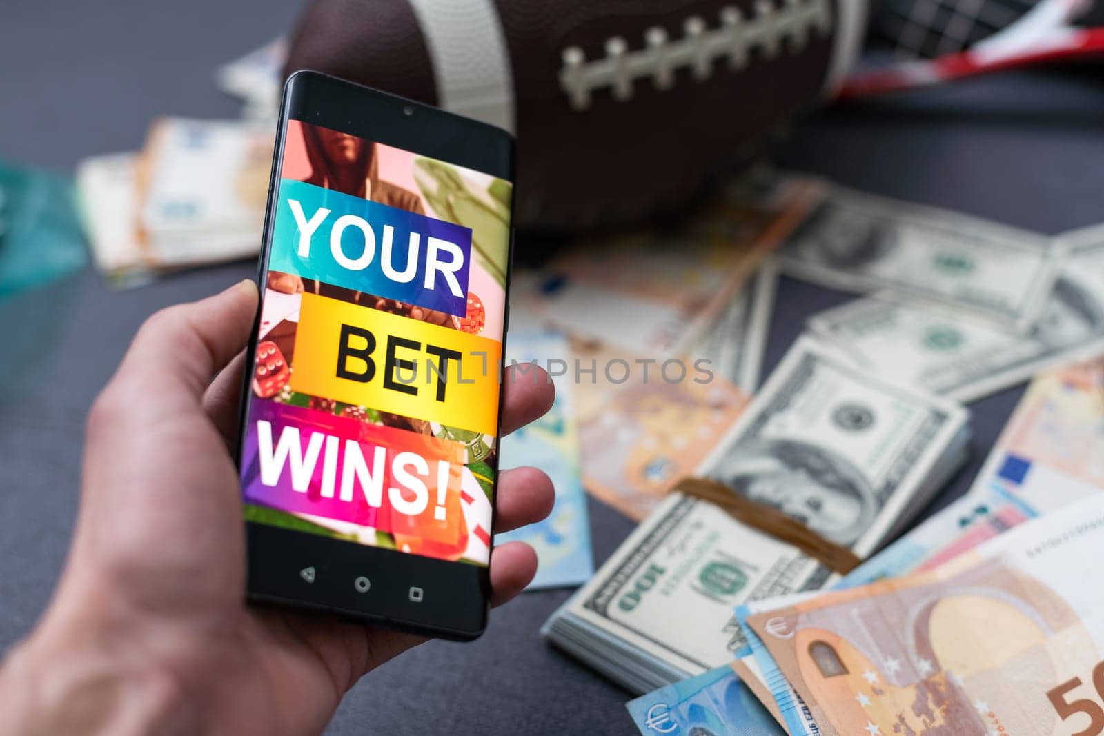 Sports betting website in a mobile phone screen, ball, money by Andelov13