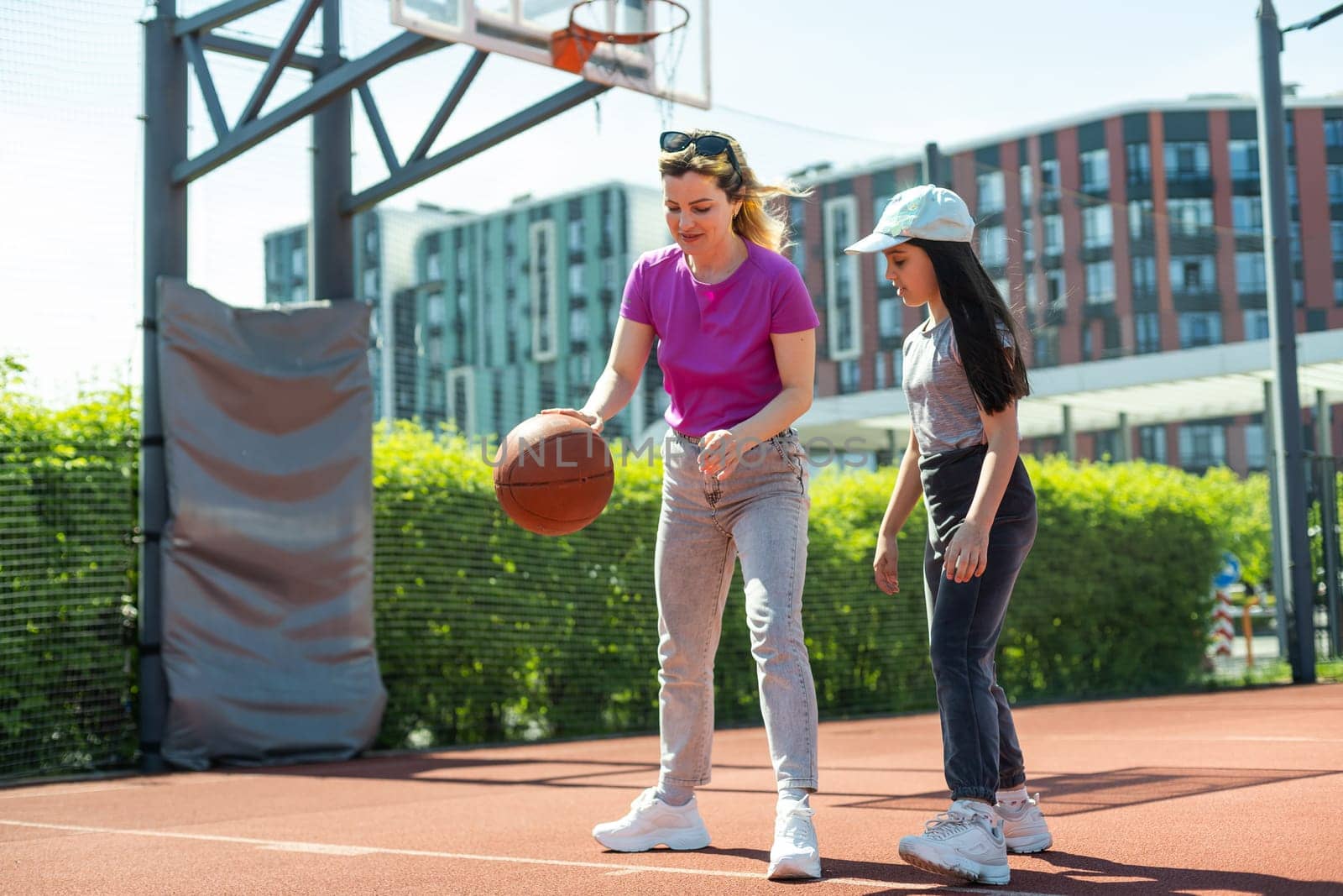 Mother and daughter playing basketball. by Andelov13