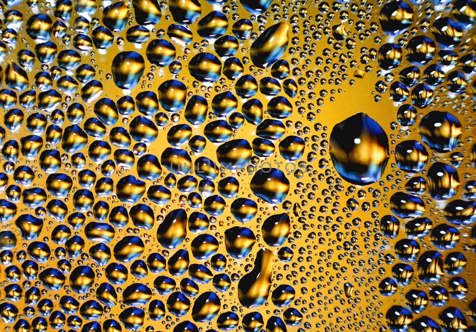 Abstract water drops on yellow background texture. backdrop glass covered with drops of water. bubbles in water. Background with Beautiful Big Drop