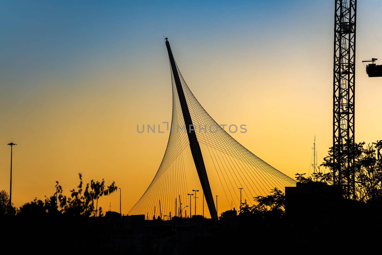 The Chords Bridge - light rail and pedestrian bridge at the entrance to Jerusalem. Bridge silhouette in sunset light