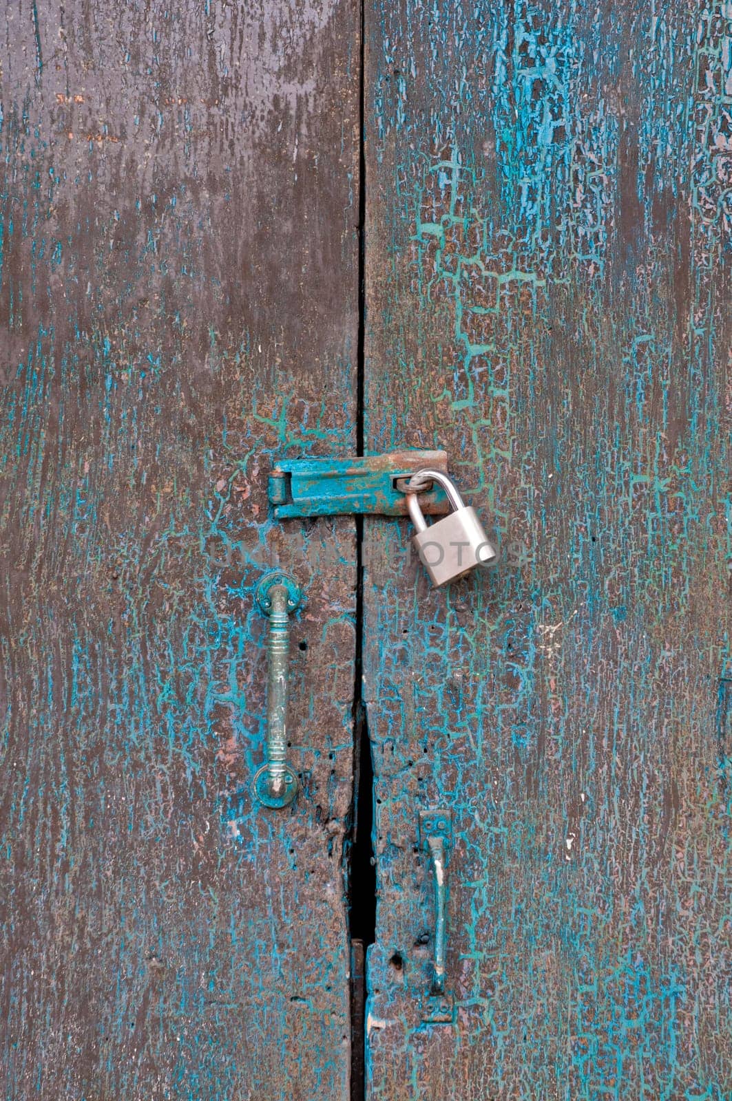 Old dark cyan wooden closed door of a traditional house in Asia  by eyeofpaul