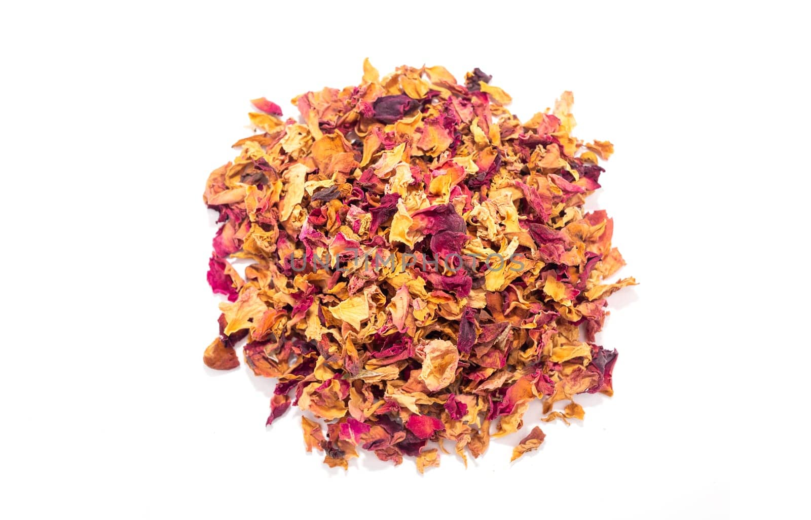 Handful of isolated dried rose petals, leaves, buds on white background. Desiccated colorful flower petals for aromatic herbal tea, beverage. Horizontal plane, close up, top view. High quality photo
