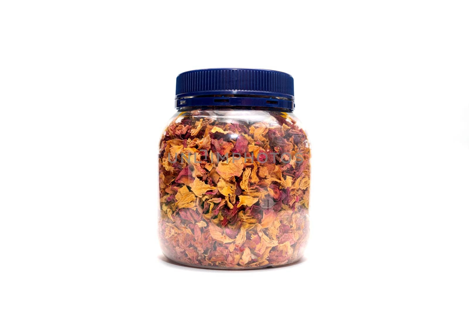 Isolated dried rose petals, leaves, buds in jar, plastic container on pink background on white background. Aromatic herbal beverage,drink made from fragrant buds of desiccated rose flowers.Horizontal