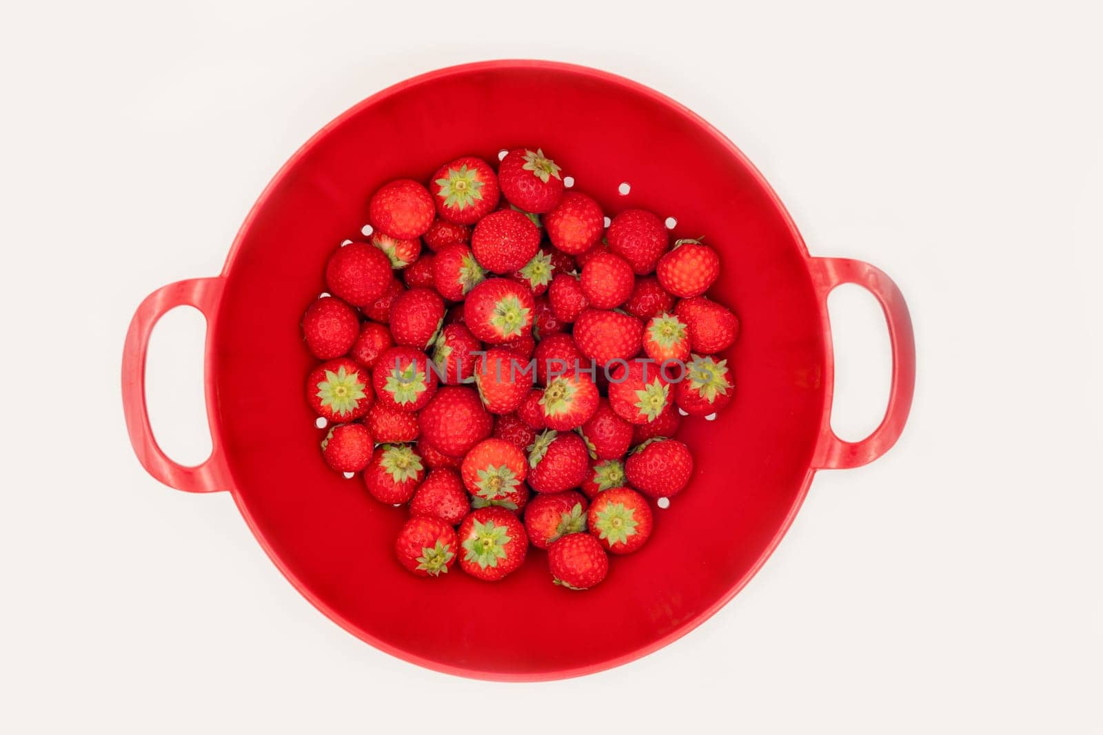 Strawberry in a red plate top view