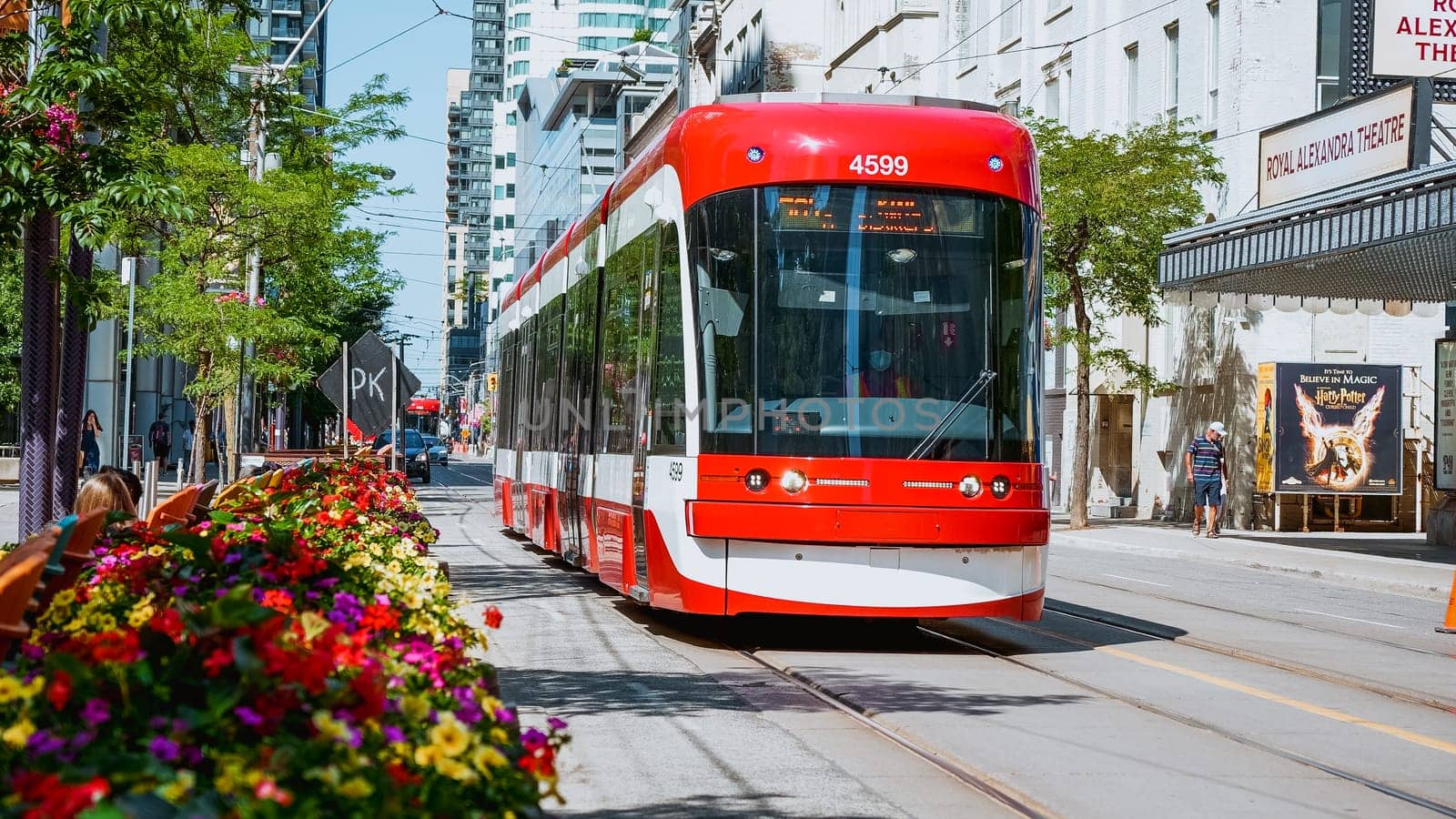 Street view of new TTC Bombardier-made streetcar in downtown Toronto's entertainment district. New Toronto Transit Commision tram on streets of Toronto. TORONTO, ON Canada - July 4, 2022