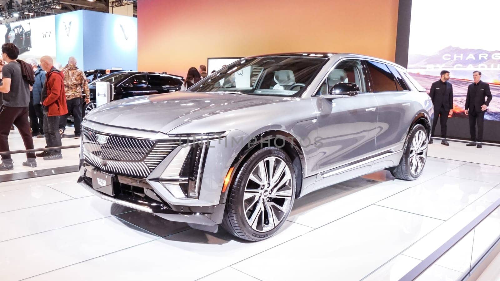 Crowds looking at new car models at Auto show. Cadillac car on display. National Canadian Auto Show with many car brands. Toronto ON Canada Feb 19, 2023