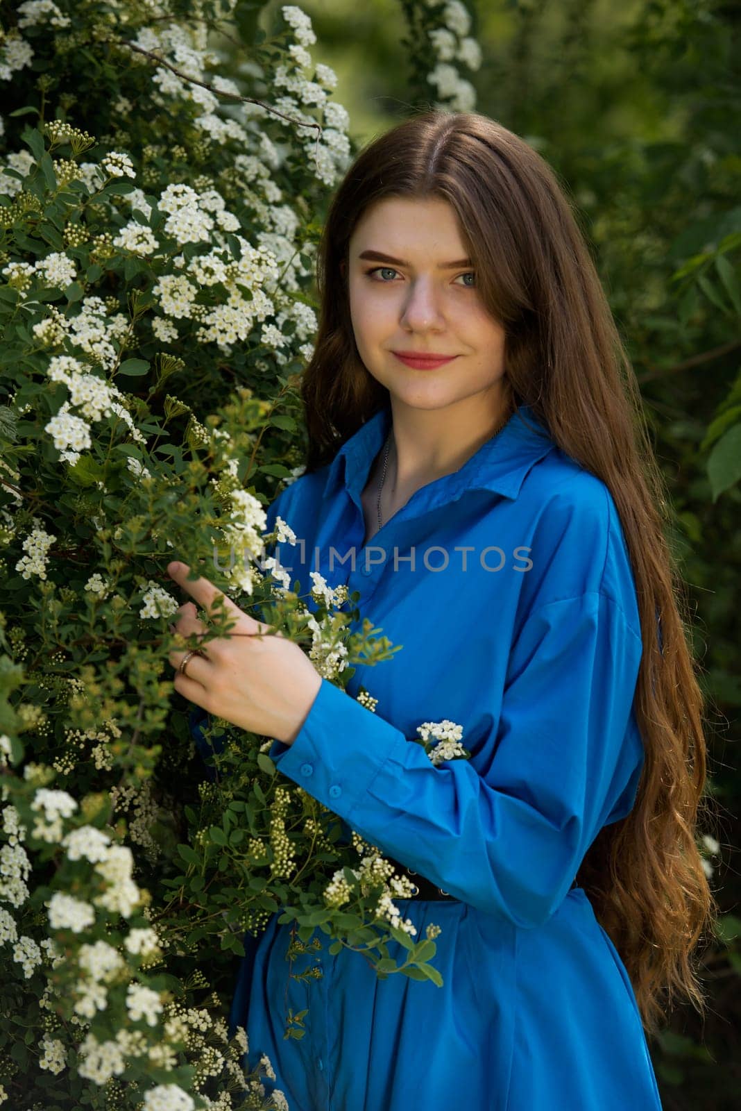 Portrait of a beautiful young woman surrounded by white small flowers. by leonik