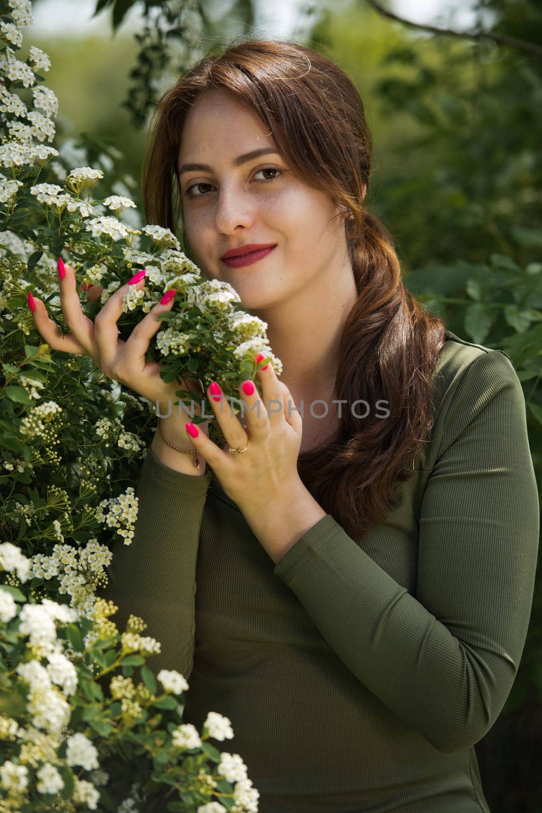 Portrait of a beautiful young woman surrounded by white small flowers. by leonik