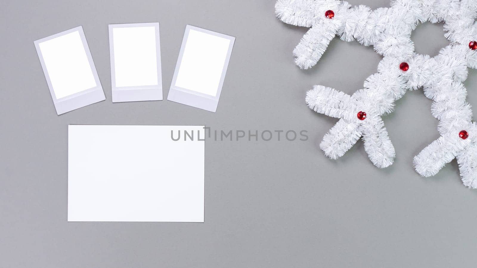 Retro photo frames isolated on grey background. Real photo template. Three frames. Mockup. Christmas white fluffy snowflake. Winter decoration
