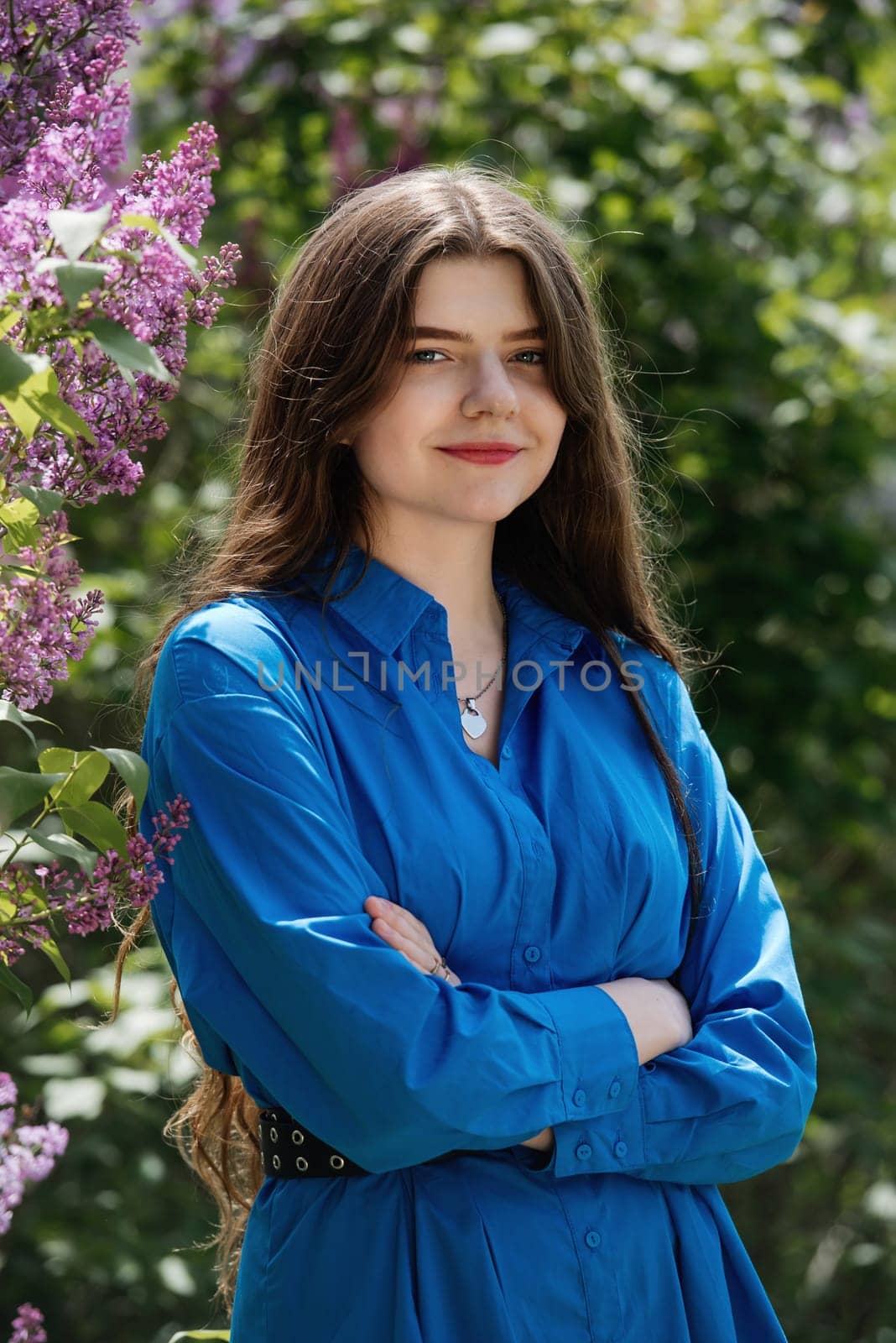 Portrait of a young woman in lilac flowers. by leonik