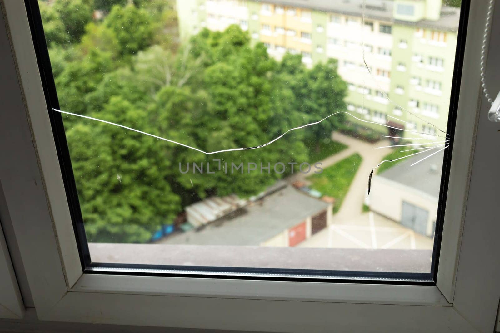 Crack, Broken Glass In A Double-glazed Window Due To Manufacturing Defect Or Temperature Difference In Building, Home. Manufacturer's Defect, Defective Products. Horizontal Plane. Closeup