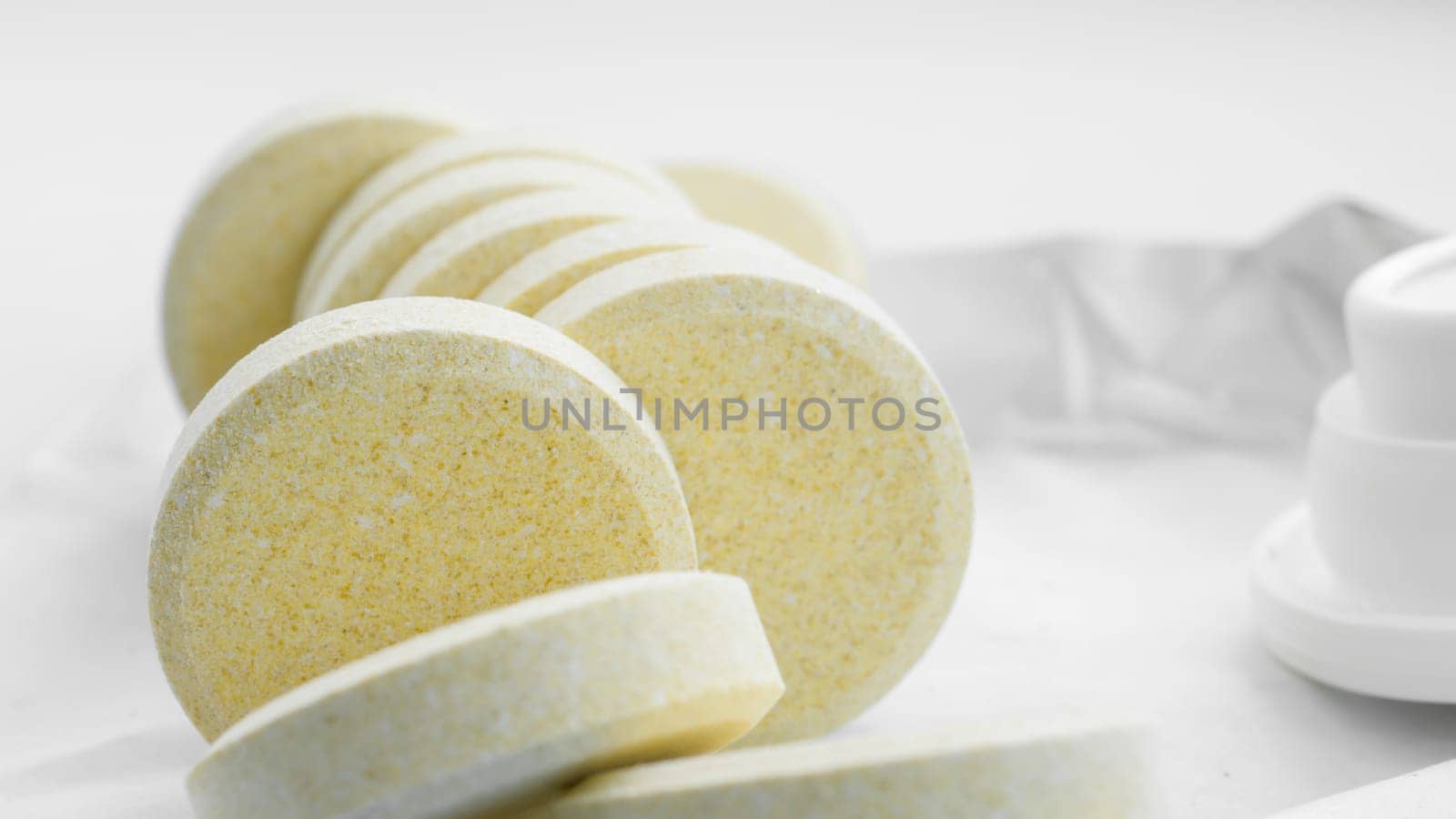 Vitamins and nutritional supplements. Heap of soluble effervescent vitamin tablets on a white background. Health care and medical. Front view.