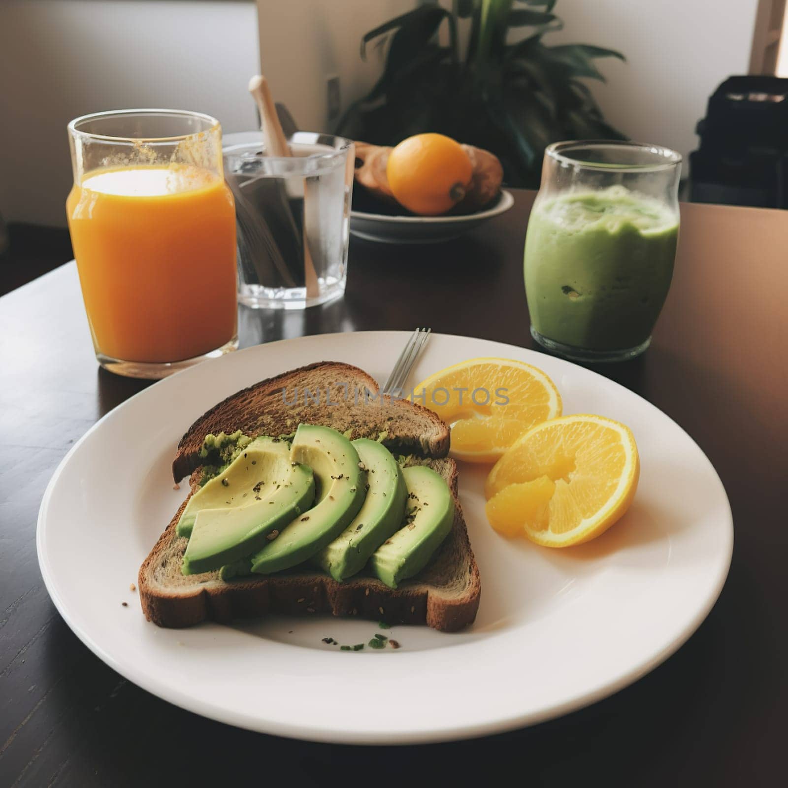 Tasty breakfast with avocado toast and orange juice by banate