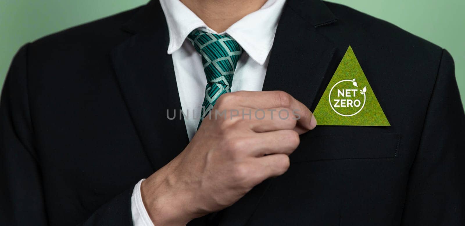 Corporate promoting sustainable and green business concept with businessman hold carbon neutral Net Zero symbol. Environmental protection effort using clean energy, zero CO2 pollution emission. Alter
