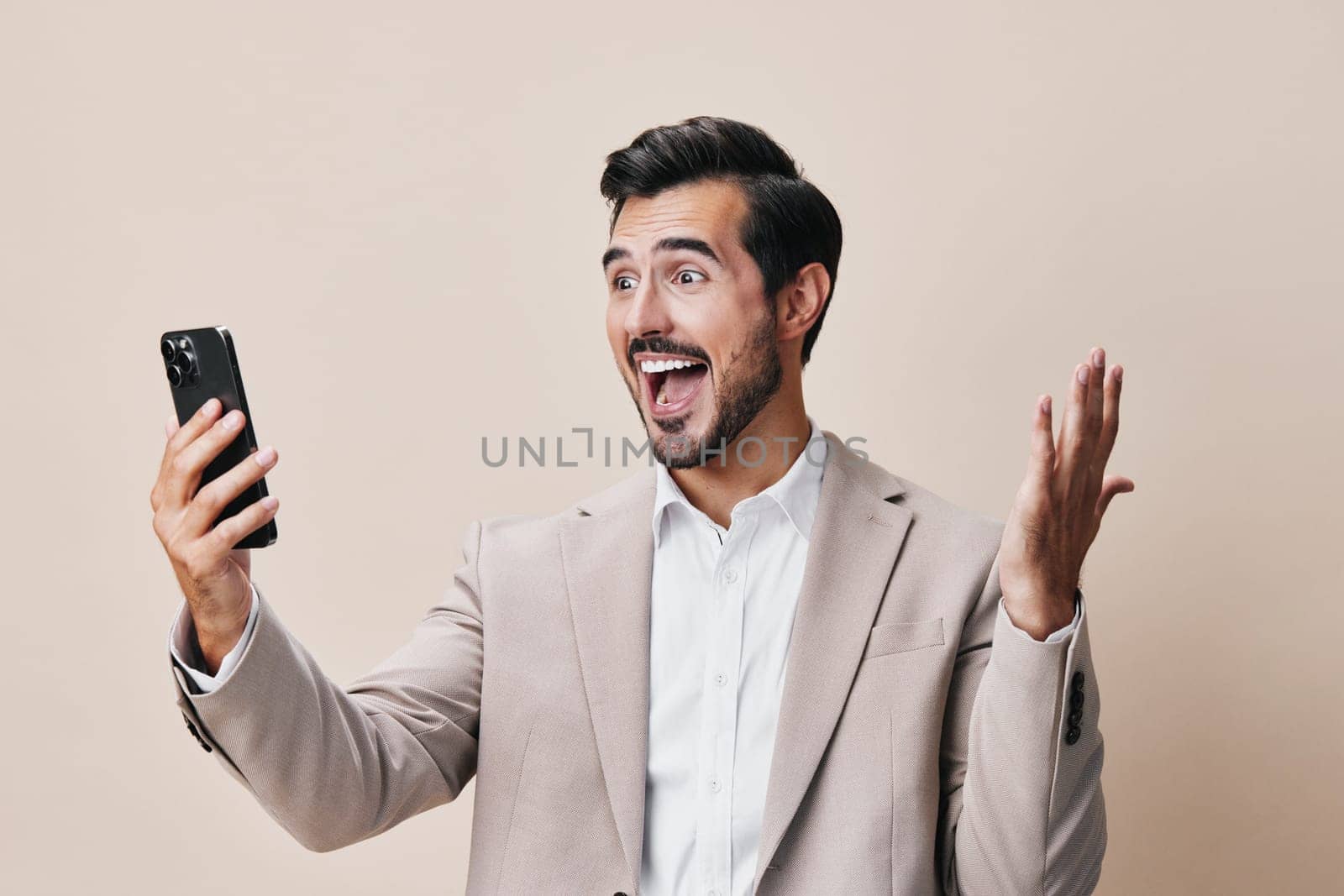 man happy businessman success cellphone phone gray call young trading hold smartphone mobile connection internet suit lifestyle smile cell business portrait