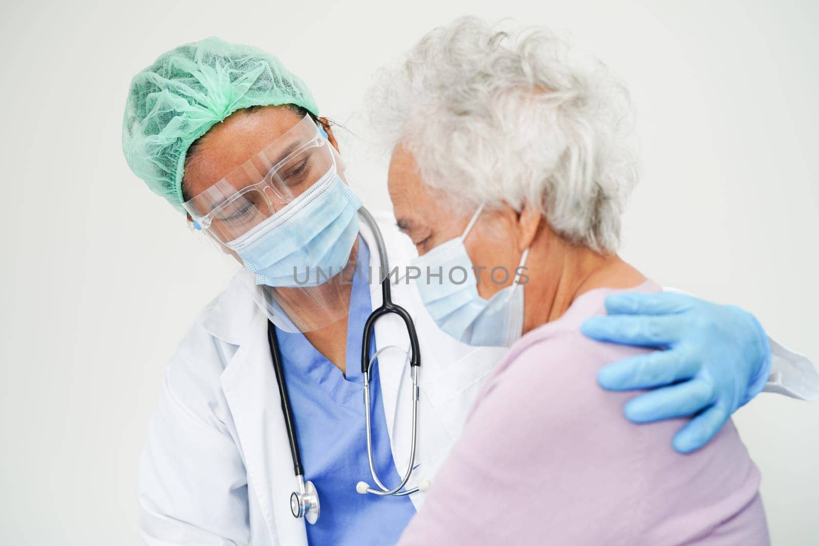 Doctor check Asian elder senior woman patient wearing a mask for protect covid coronavirus.