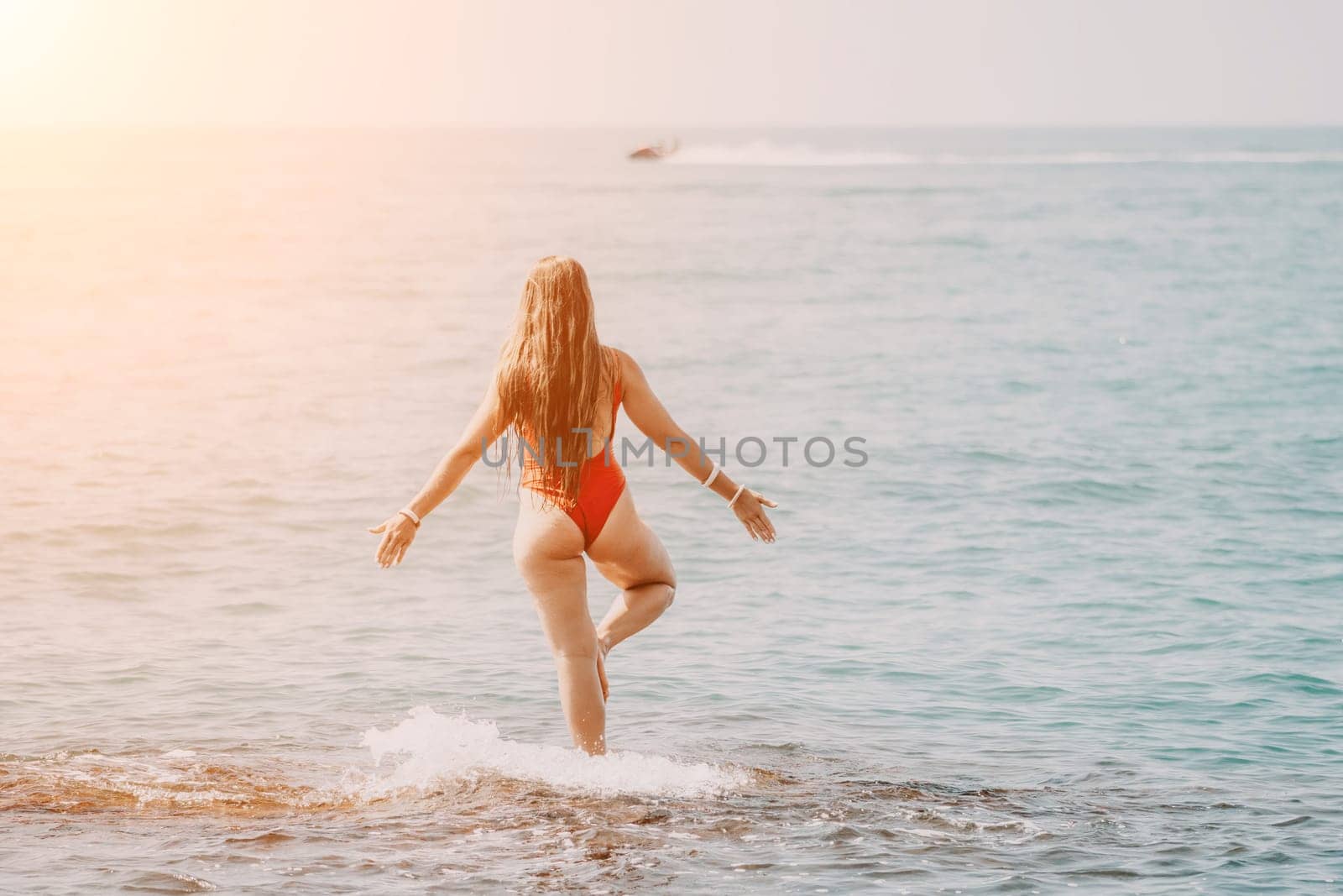 Woman sea yoga. Back view of free calm happy satisfied woman with long hair standing on top rock with yoga position against of sky by the sea. Healthy lifestyle outdoors in nature, fitness concept.