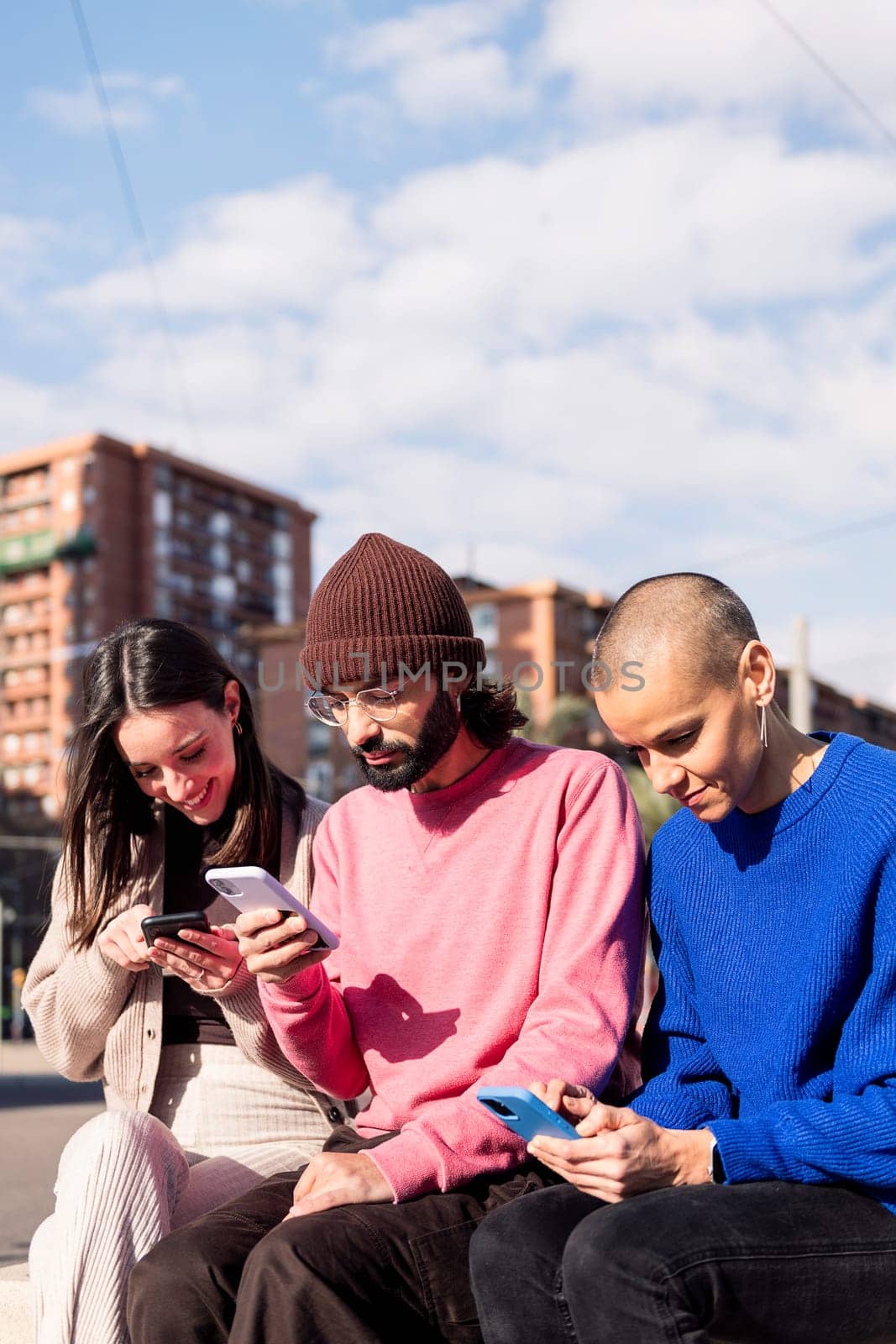 three young adults using mobile phones at city, concept of modern urban lifestyle and technology of communication, copy space for text