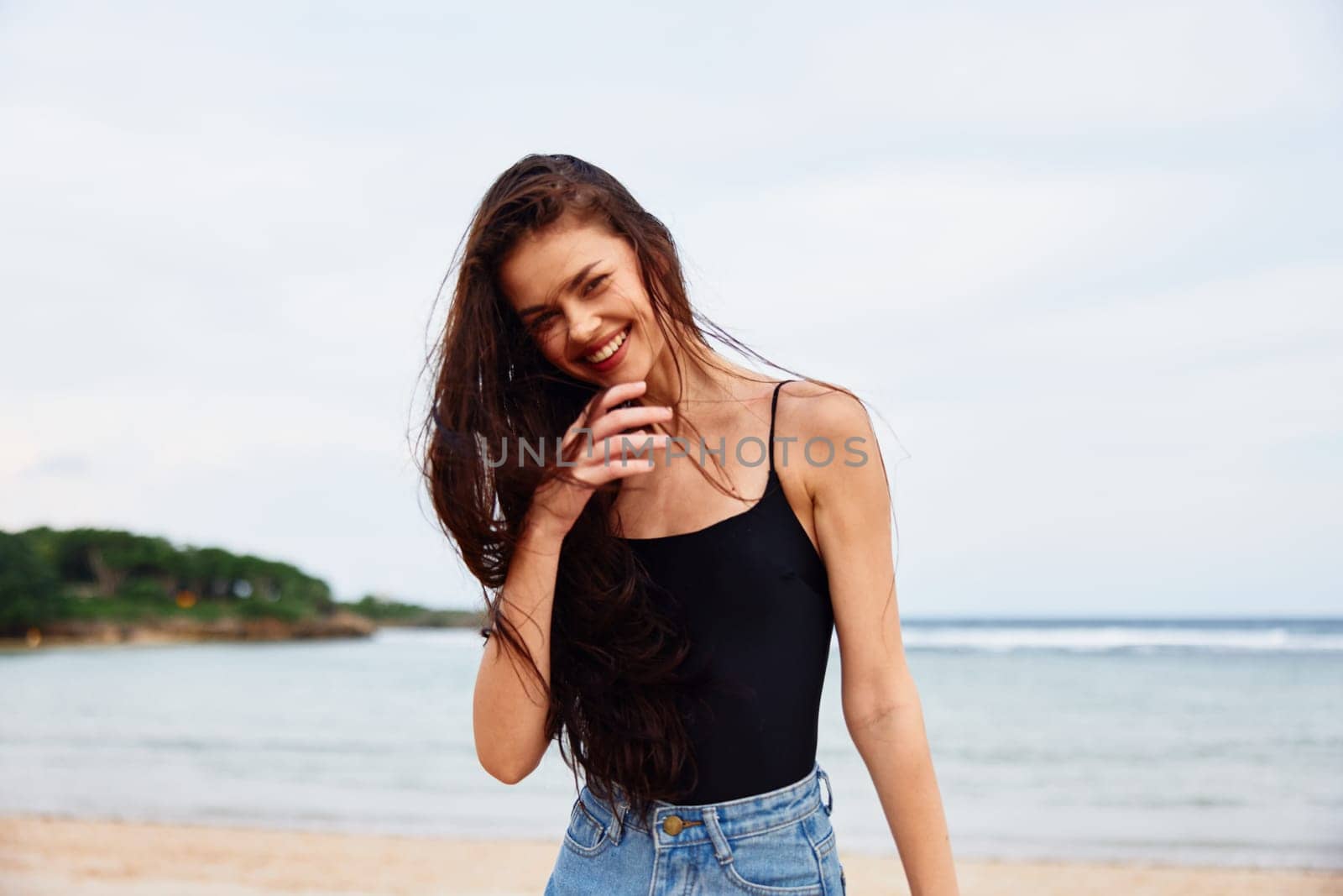 woman positive activity lifestyle shore active sand water walking young running summer sunset sea carefree tan beach travel smile vacation girl