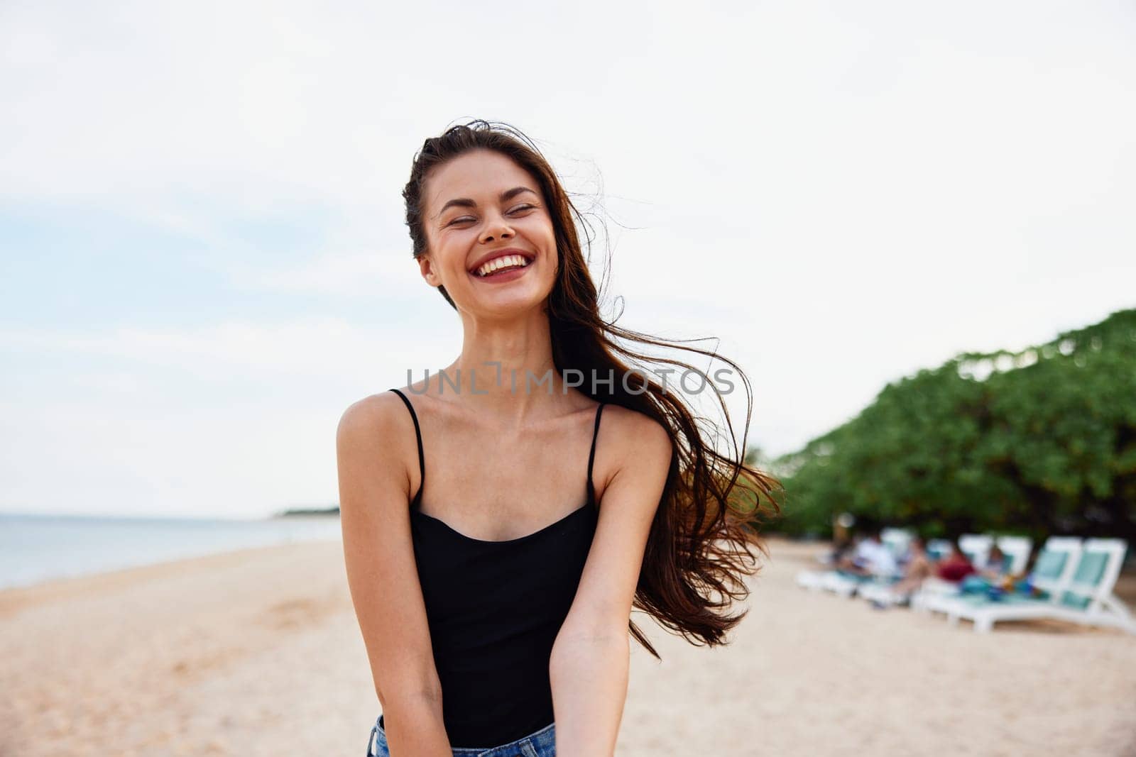 nature woman sand vacation outdoor sea summer shore walk peaceful ocean walking young beach sun dress lifestyle smile smiling female sunlight