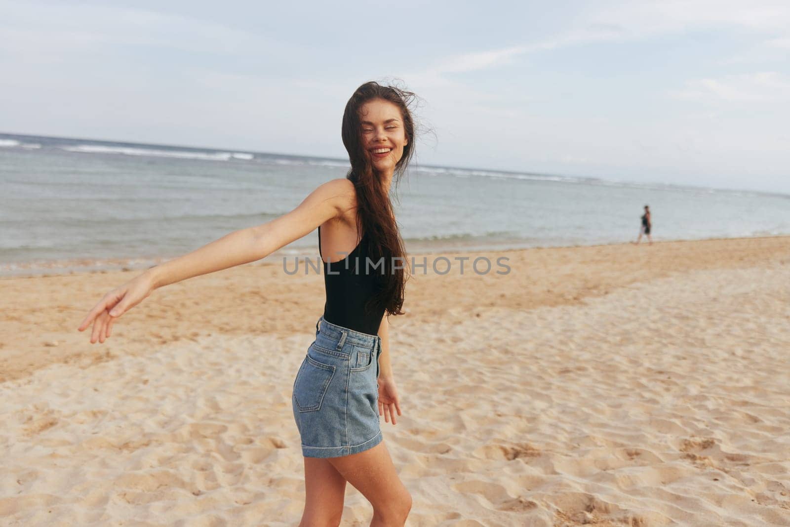 woman relax sand ocean copy-space summer dress smile sky girl female vacation carefree sunset walk lifestyle sea beach peaceful smiling jean