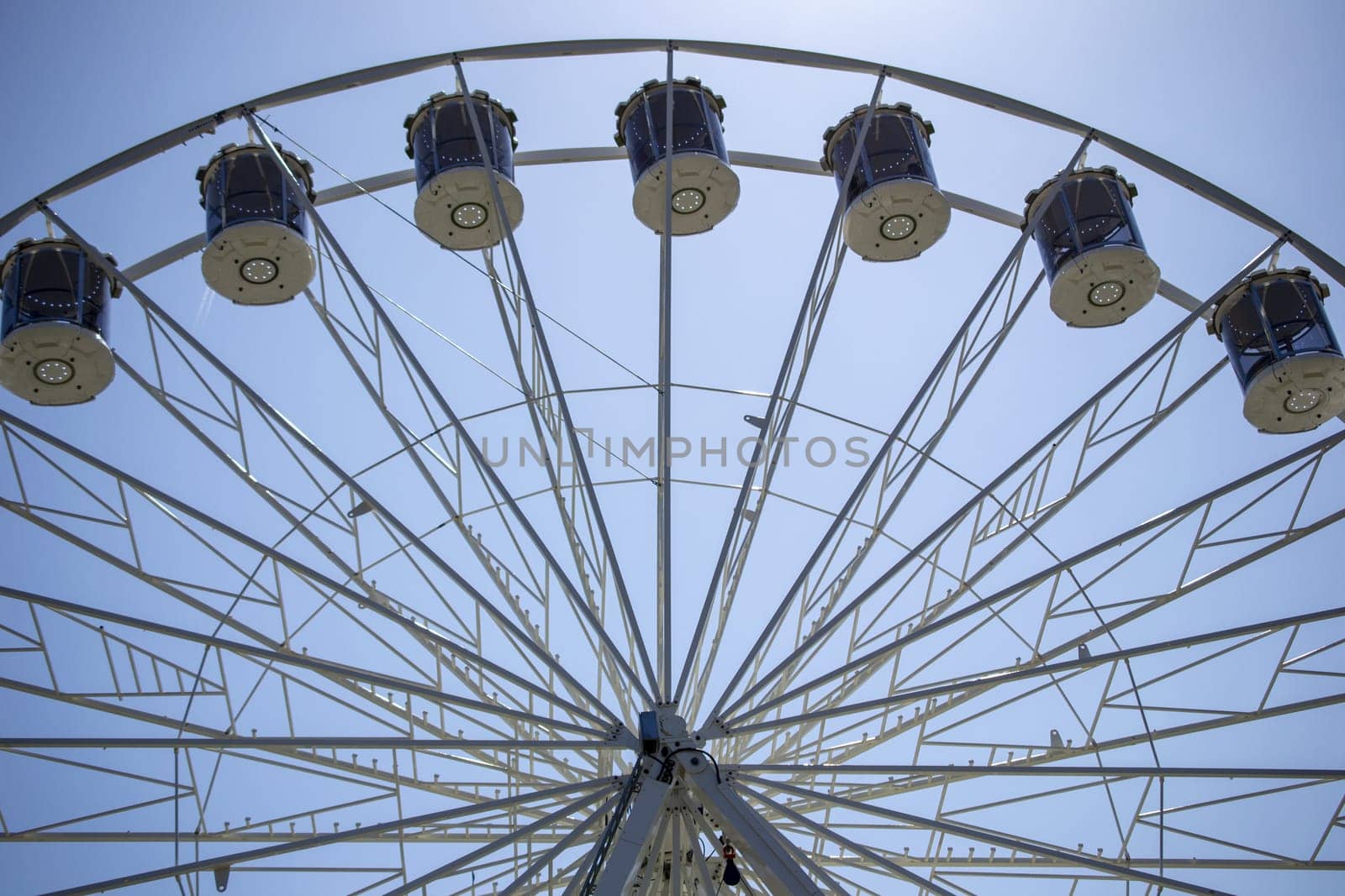 Ferris Wheel Over Blue Sky by Maksym