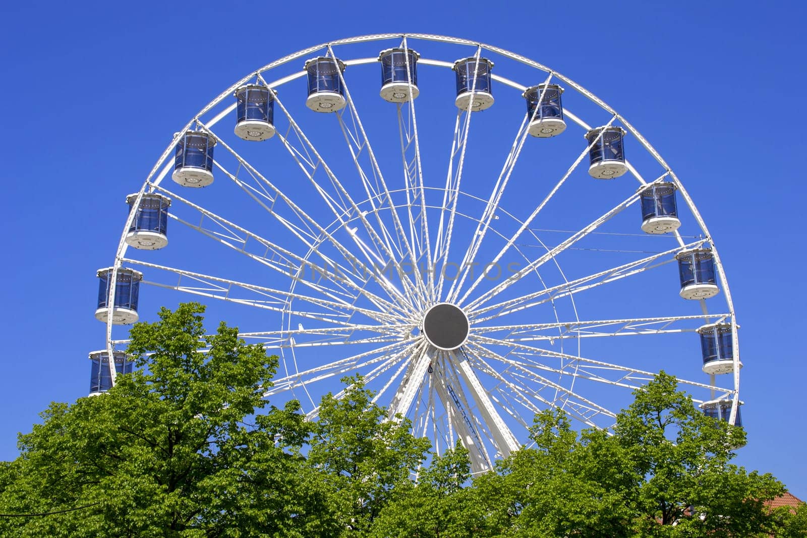 Ferris Wheel Over Blue Sky by Maksym