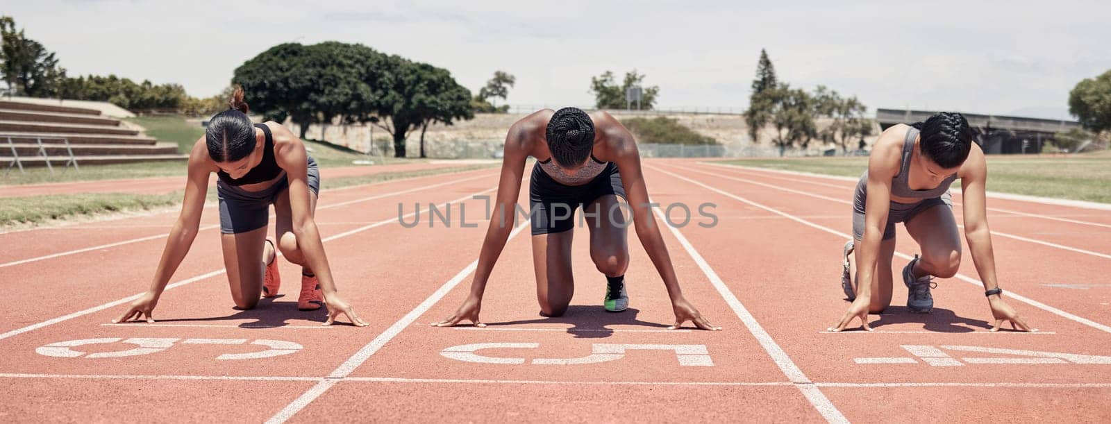 Race track, start and sports people at stadium for marathon competition, event and running with focus, energy and goal. Athlete or runner on field ground ready for speed contest or fitness challenge.