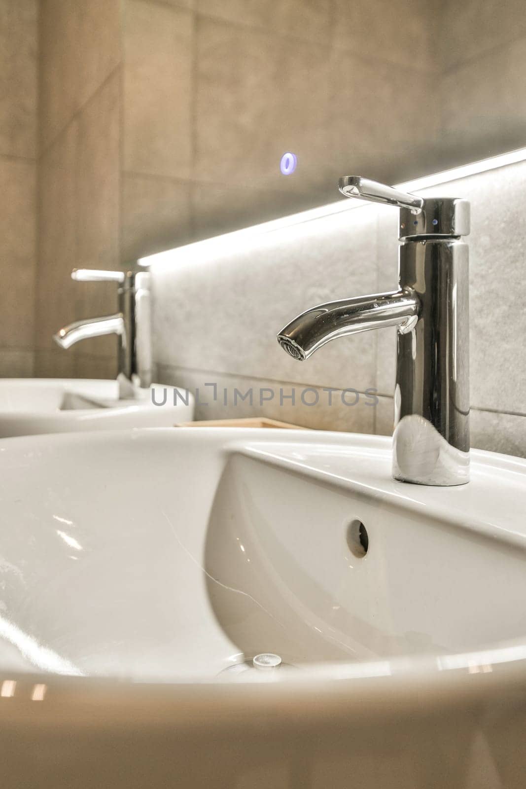 a bathroom with a sink and a faucet by casamedia