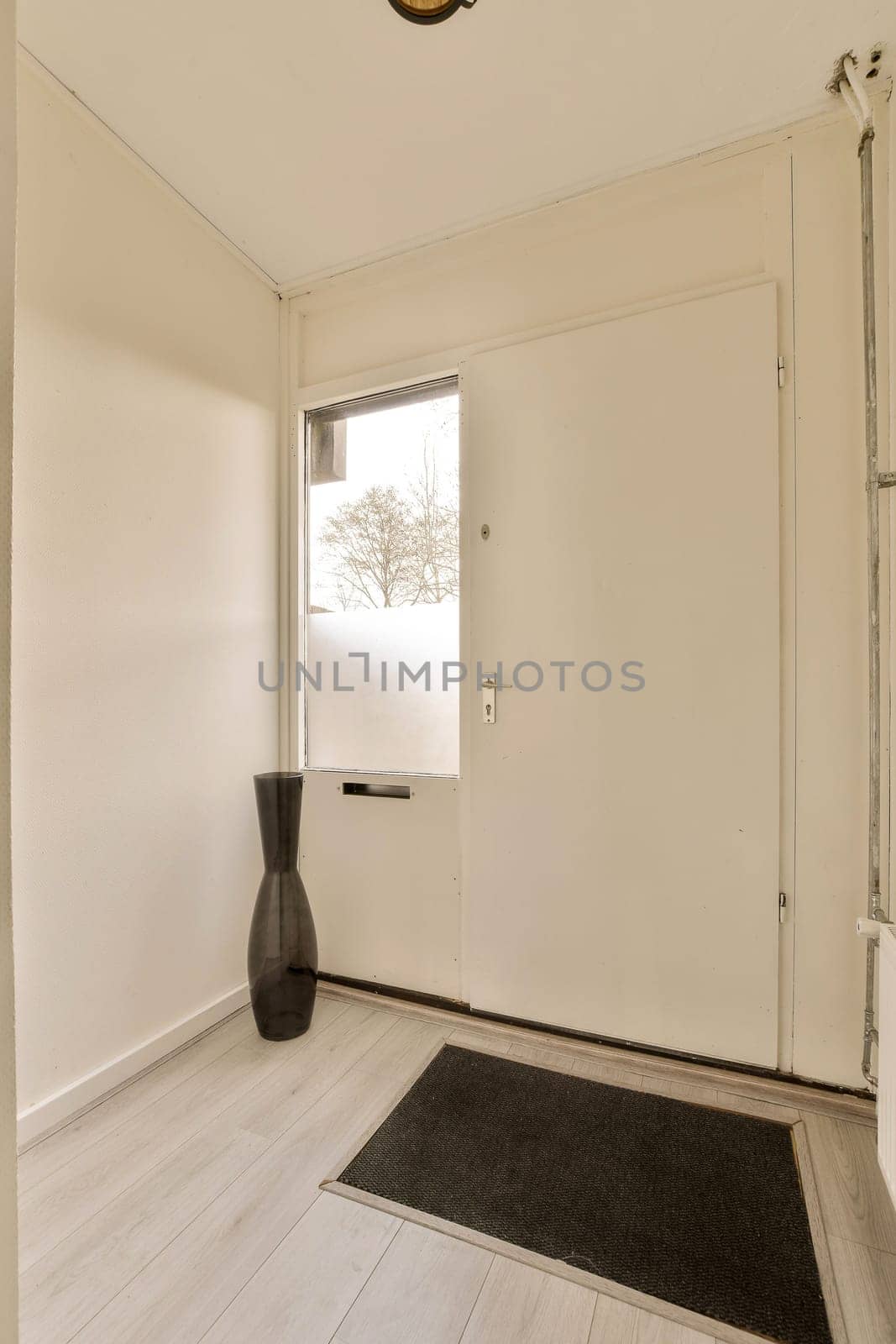 a large white room with a window and a door by casamedia
