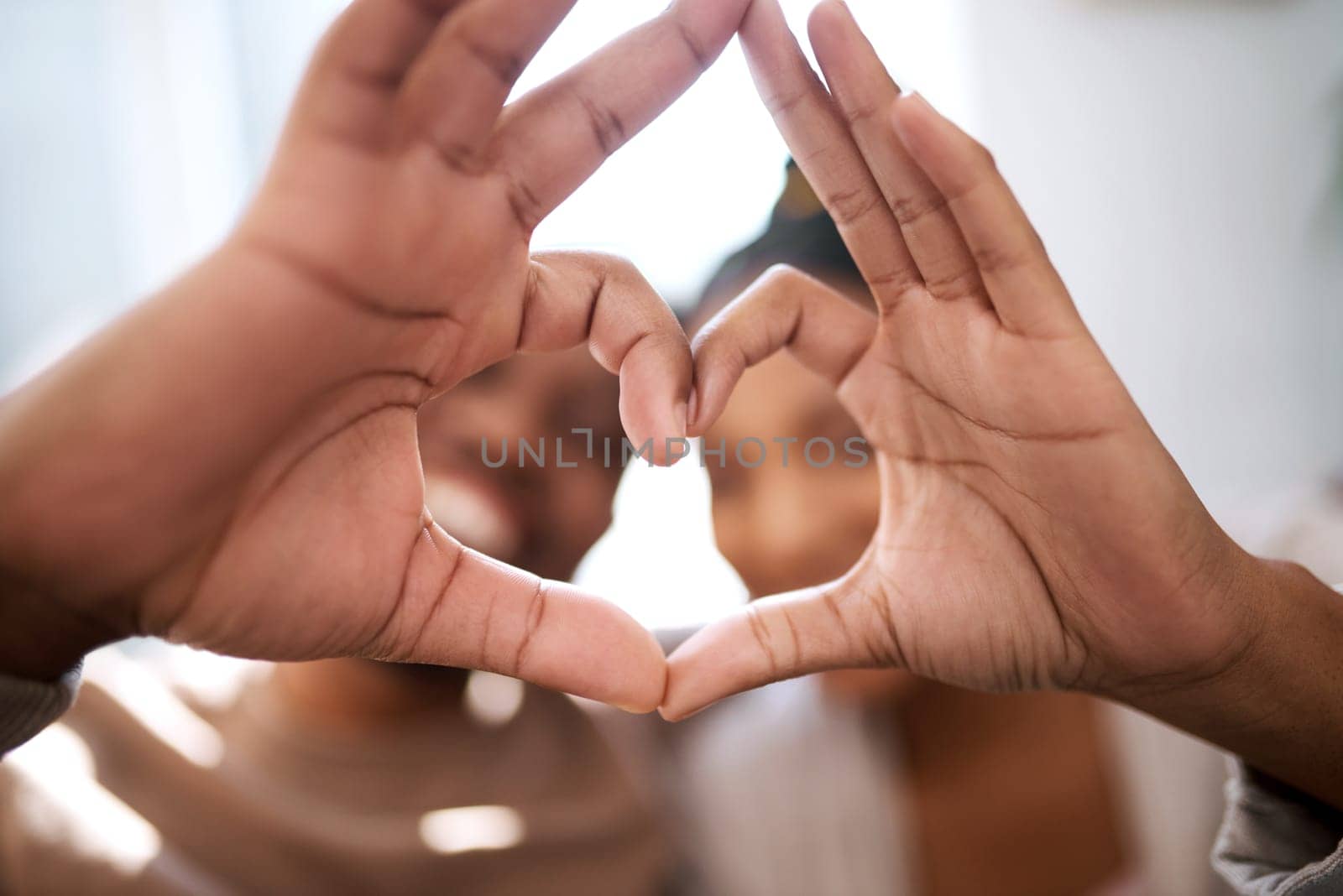 Love, heart hands and happy black couple excited for future in new home with support, trust and commitment. Romance, heart hands with black man and black woman relax on honeymoon together. by YuriArcurs