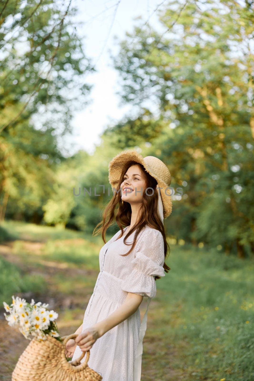 a cheerful woman with a basket in her hands walks through the woods enjoying a day off. High quality photo