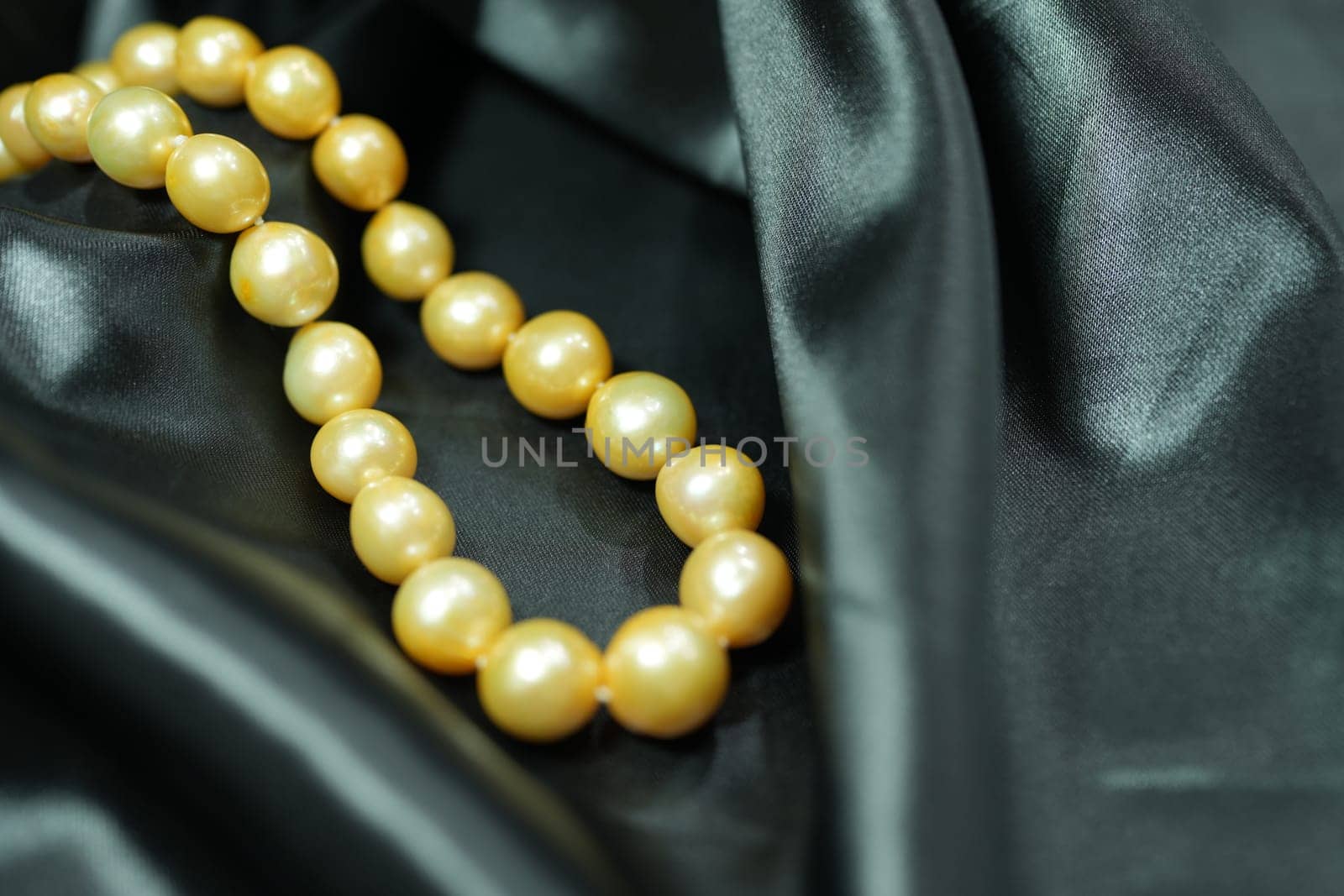Golden South sea Pearl necklace on black satin background