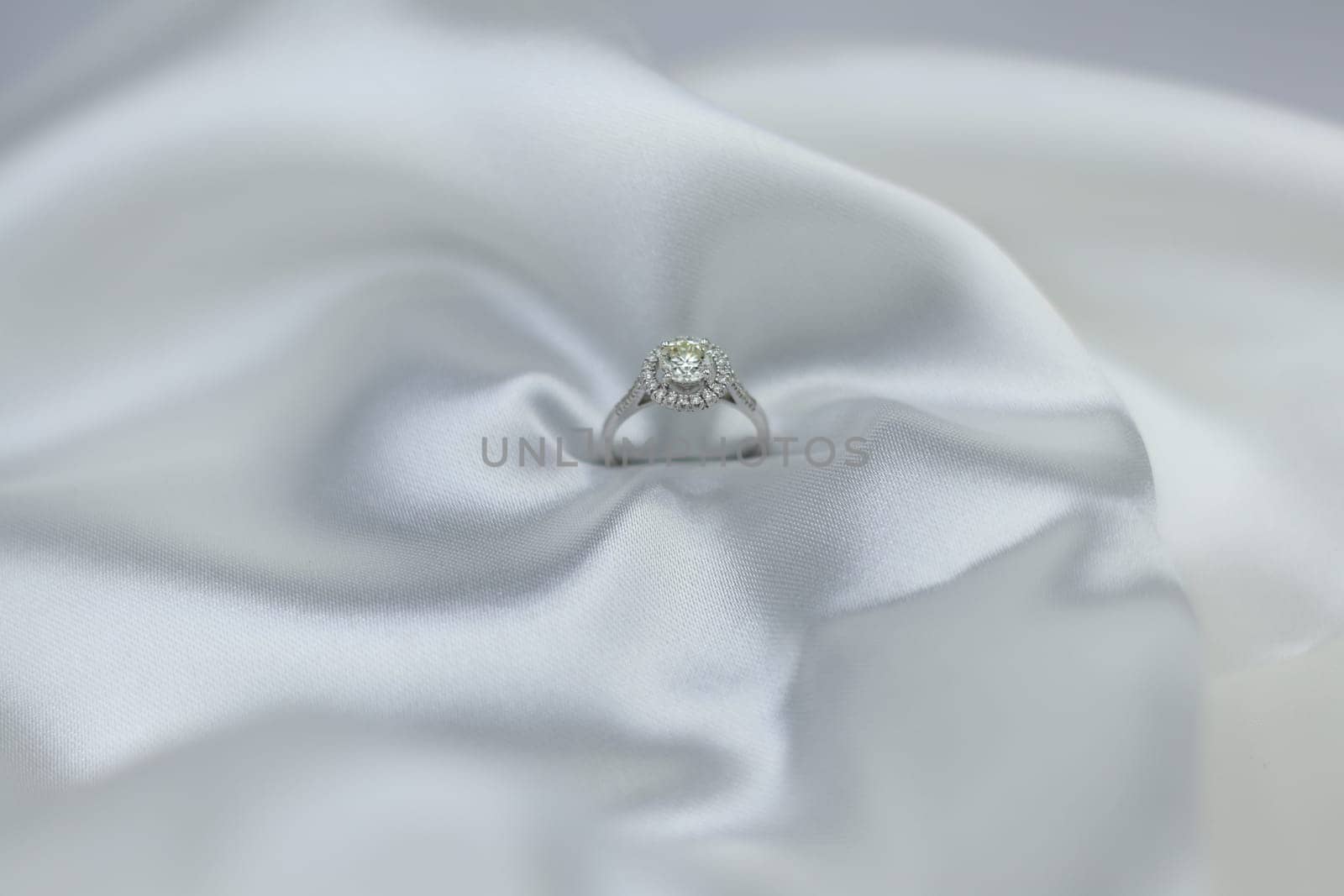 Luxury jewelryFine jewelry as diamond ring on white gold or platinum setting with red white fabric background. Jewelry shop concept