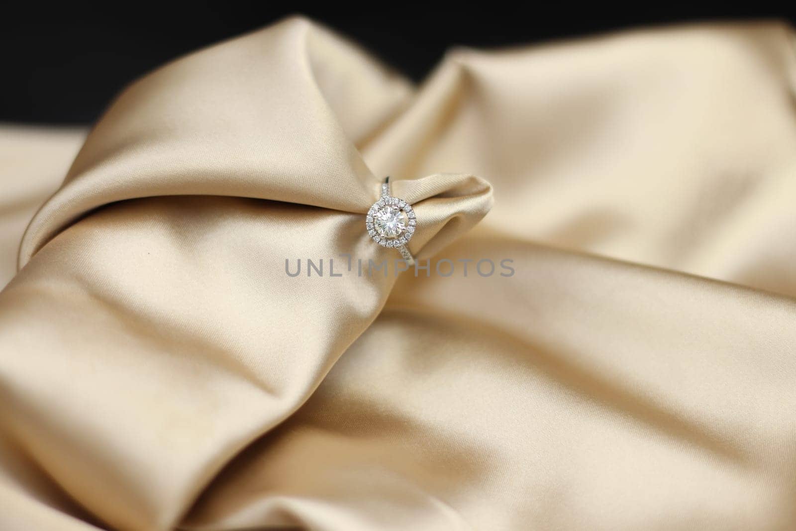 Luxury jewelryFine jewelry as diamond ring on white gold or platinum setting with red golden fabric background. Jewelry shop concept