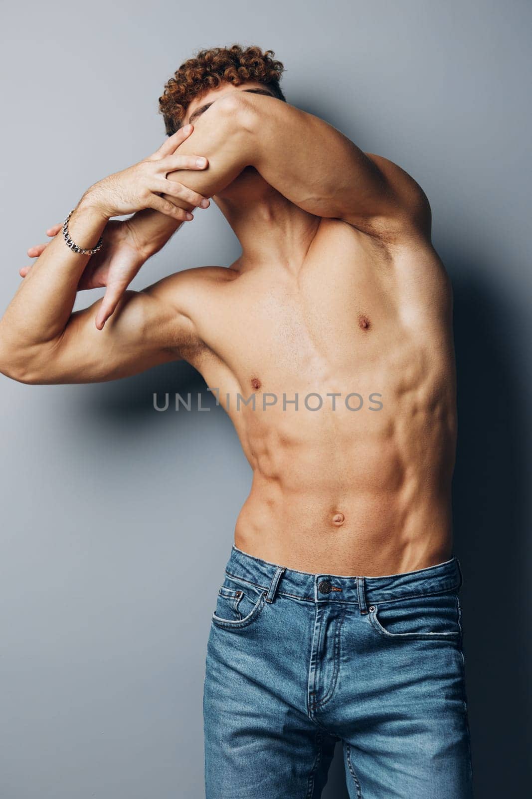 man sexy fitness adult naked strong studio chest gray lifestyle young shirtless athletic beauty background smile curly guy male