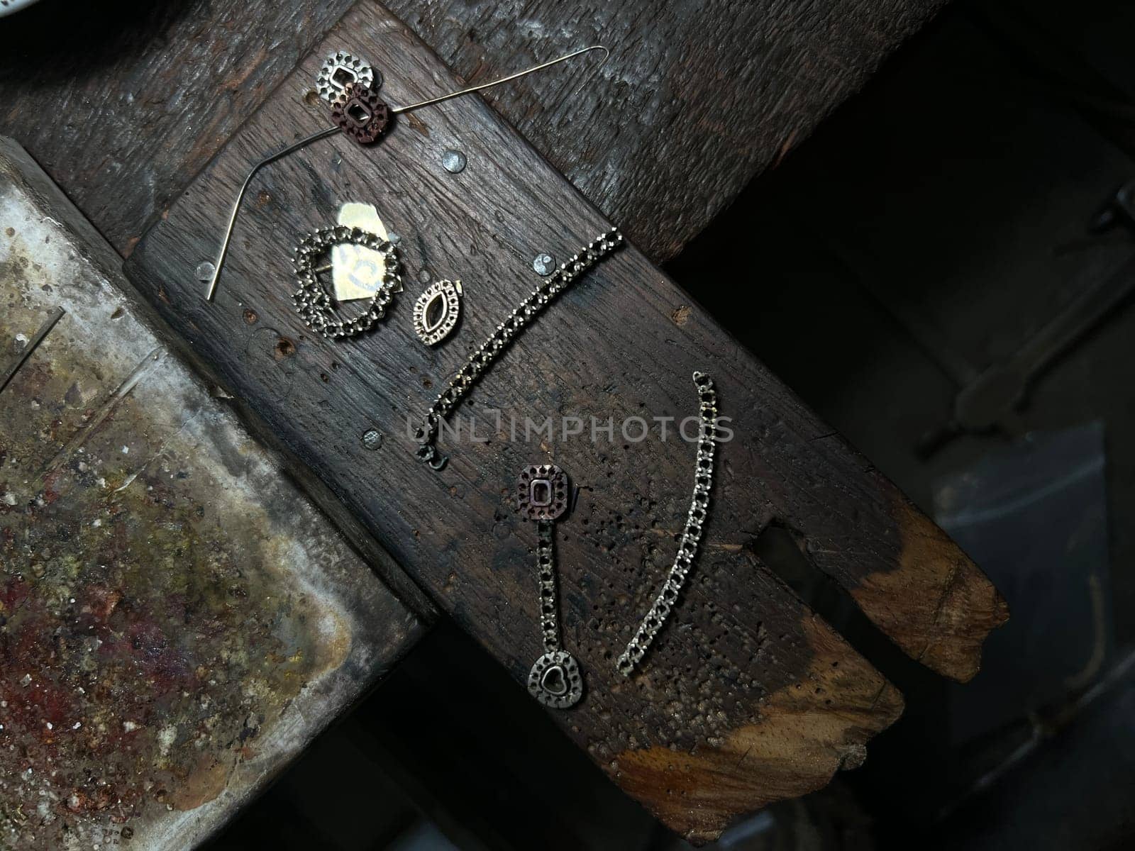 Old wood table for goldsmith with gold ring. Jeweler in Asia. Ancient and handmade jewelry work