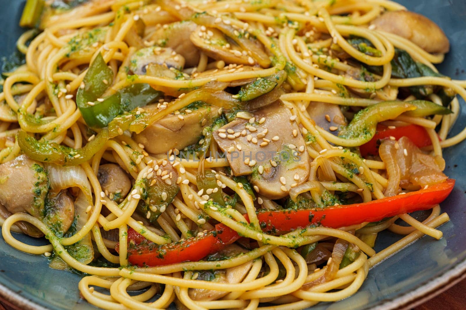 Spaghetti and vegetables wok with soy sauce. Close-up of restaurant dish