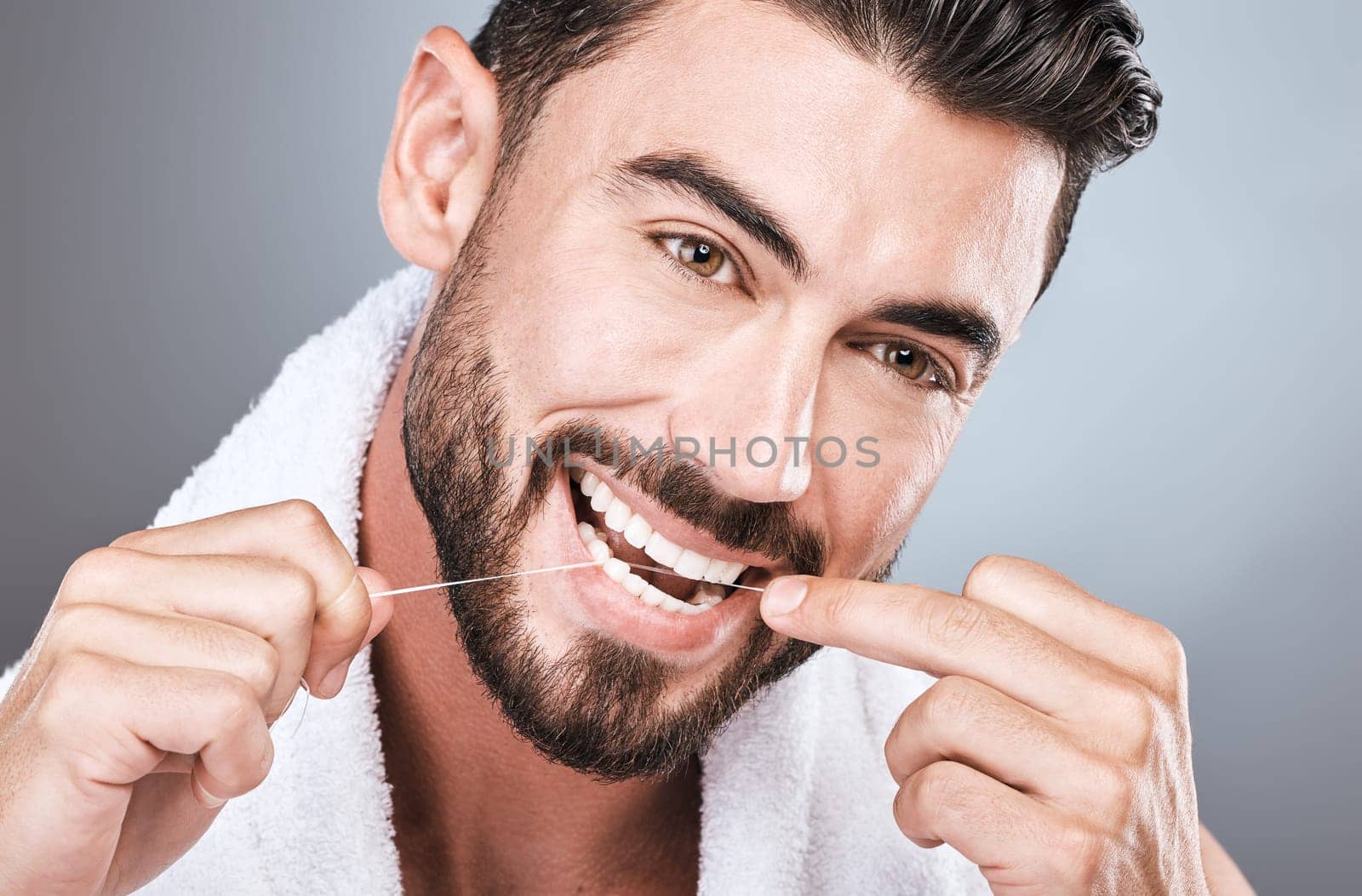 Mouth floss, tooth and man in studio for wellness, healthy body care or hygiene on background. Teeth, flossing and guy with dental cleaning for facial beauty, fresh breath or happy bathroom cosmetics.