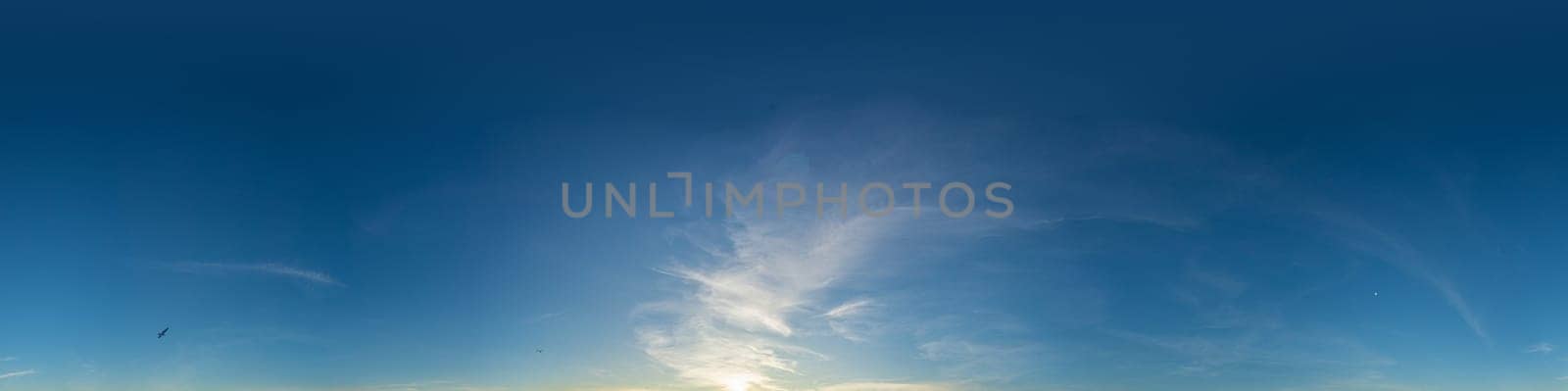 Bright sunset sky panorama with Cirrus clouds. Seamless hdr spherical equirectangular 360 panorama. Sky dome or zenith for 3D visualization, game and sky replacement for aerial drone 360 panoramas.