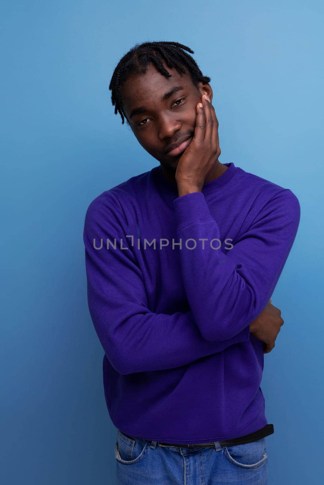 funny american young man with dreadlocks in a blue sweatshirt.