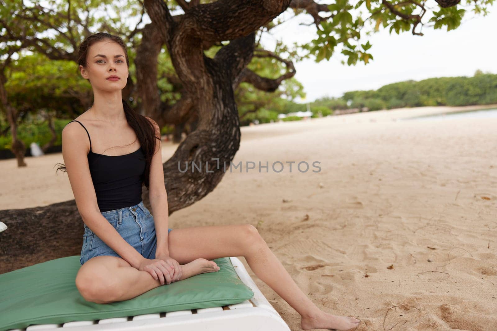 woman bikini sea beach beach sand blue caucasian girl water smiling chair sunglasses swimwear lifestyle ocean beautiful resort sunbed resting hair lying long