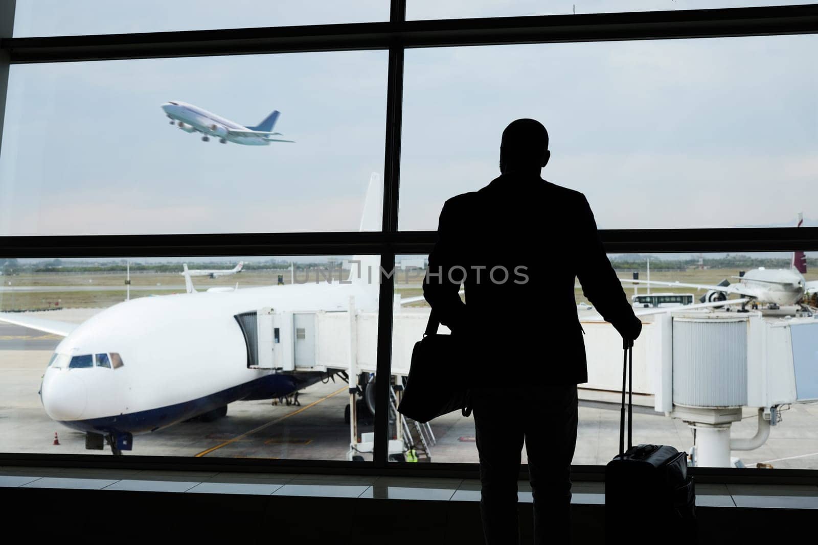 Airport silhouette, plane travel or man watch airplane fly, flight booking or transportation for world trip. Suitcase luggage, departure or back of person on holiday tour, vacation or global journey by YuriArcurs